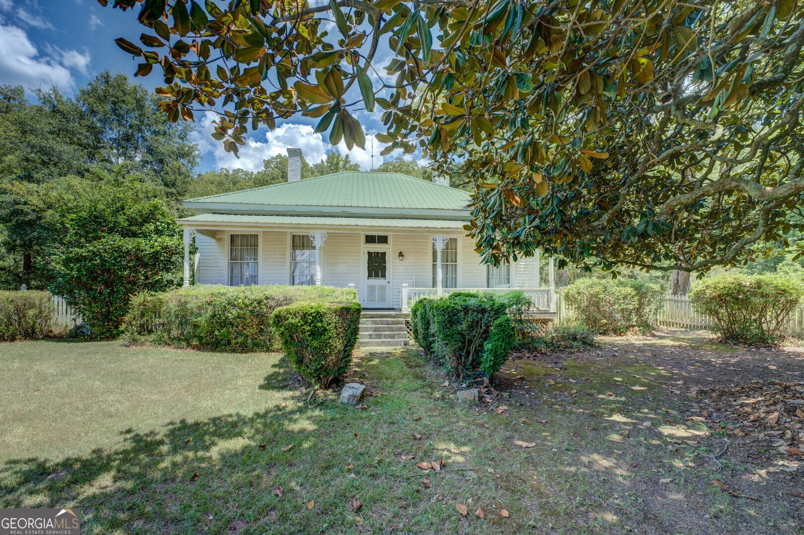 Save This Old House - 1900 Historic Farmhouse on 14.5 Acres Step back in time with this 3-bedroom, 1.5-bath 1900s-era home, nestled on a lush 14.5-acre parcel of mature trees, and timeless beauty. This historic gem is waiting to be lovingly restored to its former glory. Original pine floors and walls speak to the craftsmanship of a bygone era, while fireplaces in nearly every room offer warmth, character, and a nod to Southern tradition. The wide rocking chair front porch is shaded by towering magnolias and mature hardwoods - perfect for slow evenings and morning coffee. Outside, you'll find a white picket fence, fig trees, wildflowers, and space to garden, roam, or homestead. With plenty of room to grow, this is more than a house - it's a piece of history, surrounded by nature and full of promise. Bring your vision and passion - and help save this old house.