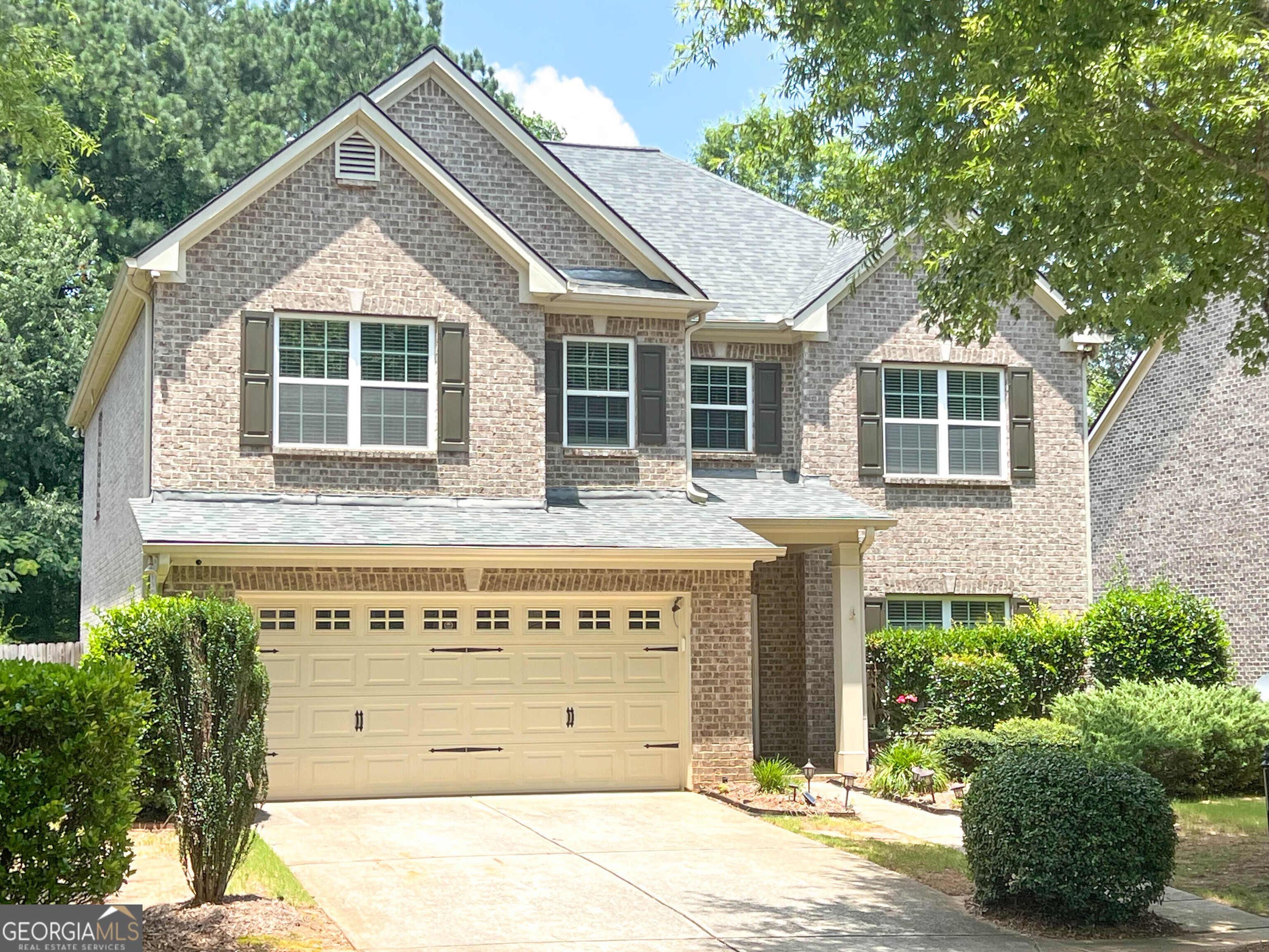Location, Location, Location! Zoned for the highly sought-after North Gwinnett High School, this beautiful home is tucked away in a quiet, gated community with charming tree-lined streets and a welcoming neighborhood feel. Step inside to a spacious, well-maintained home with an open floor plan, featuring a dedicated home office and formal dining room on the main level-perfect for working from home or entertaining. The chef's kitchen boasts a professional-grade vent hood that vents directly outside, ideal for anyone who loves to cook. Upstairs, you'll find four generously sized bedrooms, including a luxurious primary suite with a spa-like bathroom and a large walk-in closet. All secondary bedrooms are spacious and filled with natural light, offering comfort for family or guests. Enjoy outdoor living in the huge, flat fenced backyard that backs to a peaceful wooded area. The stone-paved patio provides a perfect setting for relaxing evenings or weekend gatherings. Additional features include a whole-house water filtration system for added comfort and clean living. Don't miss your chance to live in this cozy and desirable community, just minutes from top-rated schools, parks, restaurants, and shopping!