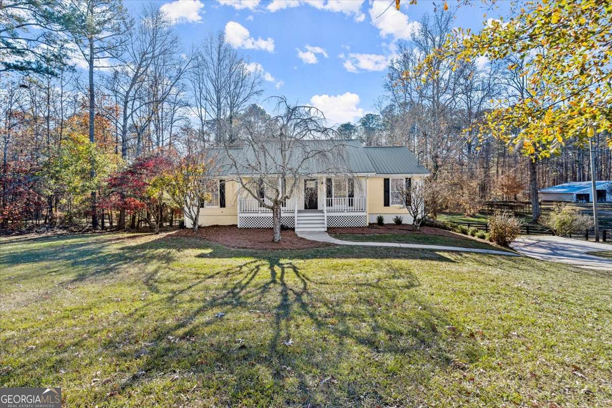 Create lasting memories in this move-in ready ranch on an unfinished basement situated on a large 1-acre estate. Welcome home to this beautifully renovated property with fresh interior paint, new deck, new flooring throughout, new interior/exterior doors, newer HVAC, new PEX plumbing, and updated kitchen and bathrooms. You will first notice the rocking chair front porch, mature landscaping, and flat lot. Experience the comfort of the spacious living room with new hardwoods that opens to the dining area with on-trend chandelier. Enjoy cooking your favorite meals in the light and bright kitchen with quartz countertops, white tile backsplash, white cabinets with on-trend hardware, can lighting, stainless fixtures, new stainless appliances including dishwasher, electric slide-in oven range, refrigerator, and built-in microwave. Getaway to the primary bedroom with new light/ceiling fan combo and new hardwood flooring. Reset after a long day in the ensuite primary bathroom with new double vanity with quartz countertop, new on-trend hardware, stylish lighting and mirror, and tiled shower/tub combo with built-in shelving. The two secondary bedrooms with hardwoods and lighting share an updated bathroom with new vanity with quartz countertop, new hardware, lighting, mirror, and shower with new glass enclosure. Relax or entertain on the new deck perfect for grilling and enjoy the expansive, flat yard. There is plenty of extra space in the unfinished basement for storage or finish for all of your lifestyle needs. Discover the possibilities with AG zoning, complete with a spacious outbuilding set on a sturdy slab - perfect for your next project or storage needs. No HOA and close proximity to parks, shopping, and restaurants complete the attributes that make this your must-have home.