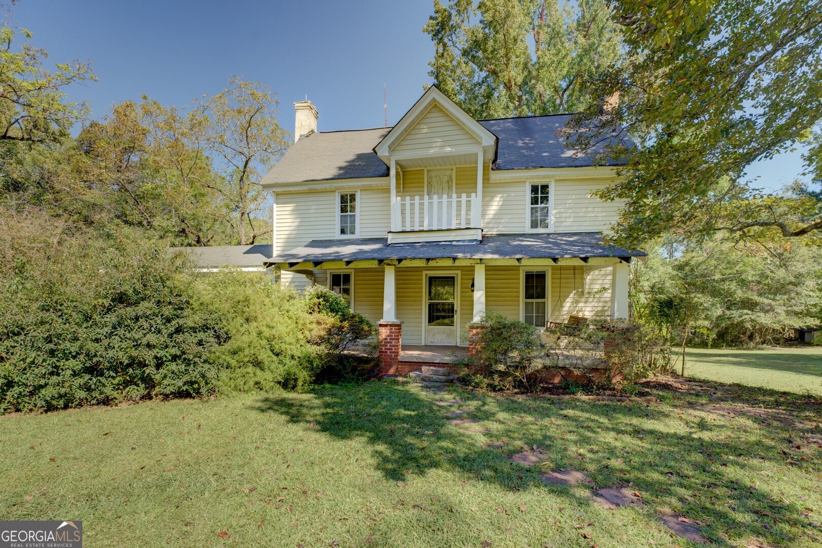 Step back in time and discover the endless possibilities awaiting at this charming 1910 farmhouse nestled on fifteen pristine acres in beautiful Walton County! This three-bedroom, one-bathroom home offers a delightful blend of historic character and modern potential, perfectly positioned for convenient access to Athens and Monroe while maintaining that peaceful country atmosphere. The original farm bell located on the property is dated 1886. So it's possible the homeplace may date prior to 1910. Once part of a working dairy farm, this property tells a story of Georgia's agricultural heritage. The spacious walk-in pantry speaks to the home's practical farmhouse roots, providing ample storage for all your culinary adventures. Above, an expandable attic offers tremendous potential for additional living space, whether you envision a cozy reading nook, home office, or extra bedrooms. The true magic lies in this property's incredible renovation potential to bring back to its original glory. The generous outdoor space provides endless possibilities. You'll enjoy the privacy and space that fifteen acres provides, complete with mature trees and open areas ideal for whatever your heart desires. Whether it's hobby farming, or simply want room to breathe, this property delivers. This farmhouse is ready for someone with vision to write its next chapter.