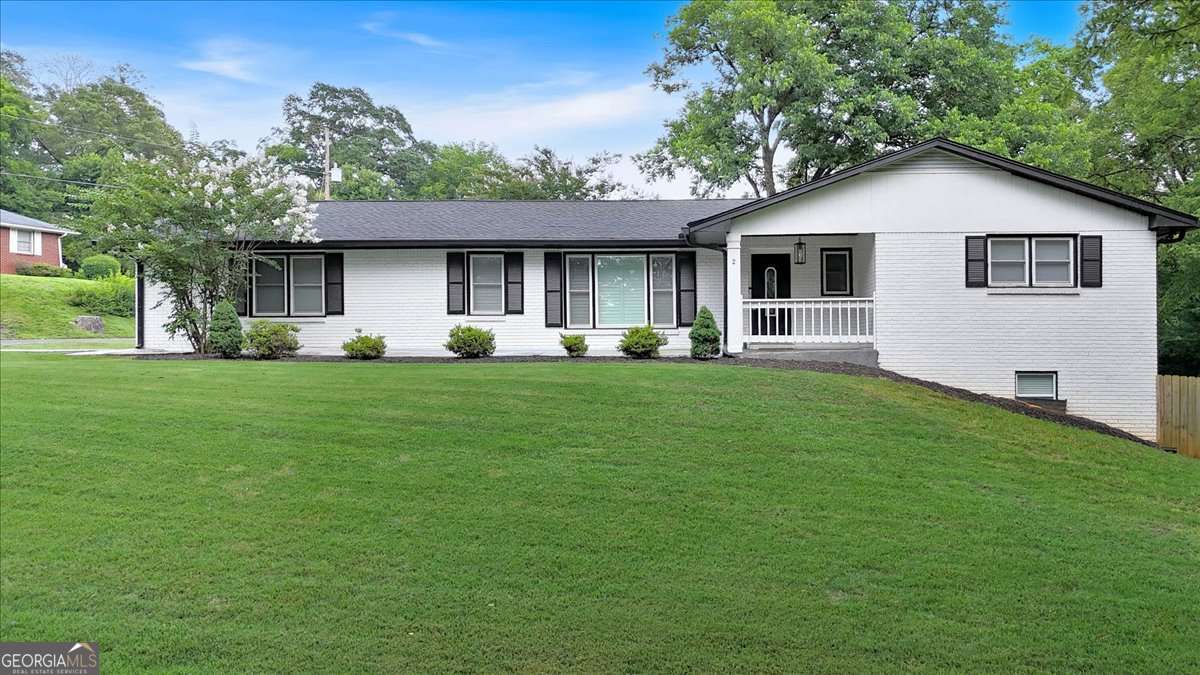Welcome home to this exquisite 4-bedroom, 3-bathroom ranch, perfectly positioned in Cartersville's highly sought-after historic district. This property delivers the best of both worlds: the enduring appeal of a historic home coupled with the convenience of modern updates. The substantial four-sided brick residence provides ample living space, further expanded by a fully finished basement that's ready for anything from a media room to extra guest quarters. Its prime location means you're mere steps from the heart of downtown Cartersville, offering an incredible variety of local entertainment including charming restaurants, the popular farmers market, and lively festivals, all less than half a mile away. Step inside to discover a beautifully opened floor plan that flows effortlessly. Details like elegant plantation shutters, granite counters, painted wood cabinets, and newly updated light fixtures enhance the home's sophisticated feel. You'll also appreciate the dedicated wardrobe room, offering excellent storage. Start your mornings with a cup of coffee on the welcoming front porch, overlooking the generously sized corner lot. Evenings are perfect for grilling and entertaining on the back deck. Situated within the coveted Cartersville City School district and notably a non-HOA property, this home is perfect for families prioritizing top-rated education and a vibrant, walkable lifestyle. This is a rare opportunity to own a significant piece of Cartersville's history, complete with all the modern comforts, in one of its most desirable areas.