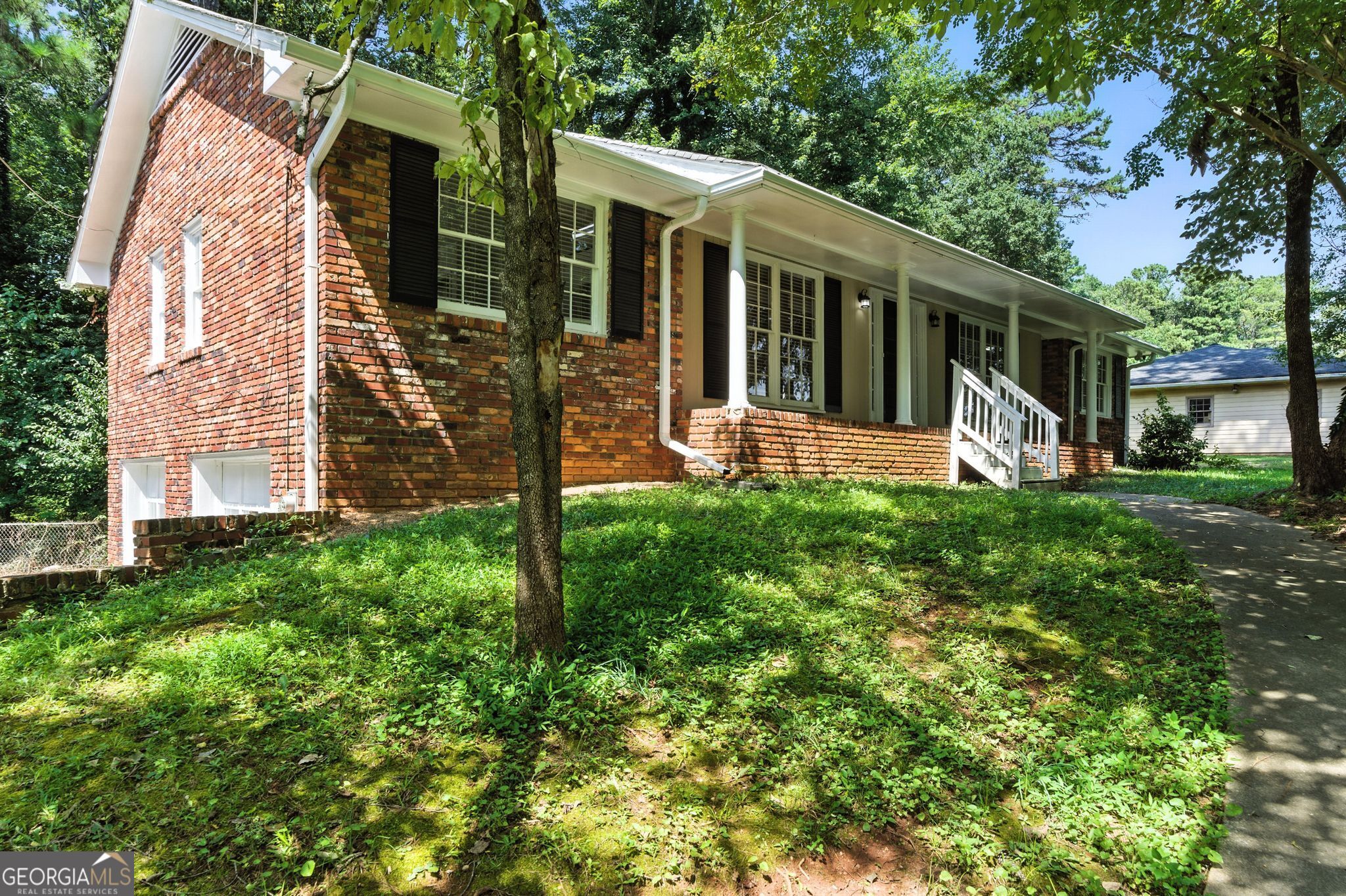 Welcome to this classic 3-bed, 2-bath brick ranch in East Point's quiet Meadow Lark Estates. Built in 1958, the home features original hardwood floors, a cozy fireplace, and a functional kitchen with ample cabinet space. Both bathrooms are bright with tiled finishes, and a partially finished basement offers extra living or storage space. Set on nearly half an acre, the wooded backyard is perfect for relaxing or entertaining. With an attached garage and carport, plus quick access to Camp Creek Pkwy and the airport, this home blends charm, space, and convenience.