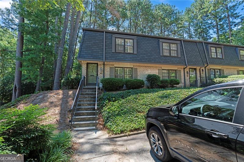 Desirable end-unit 2-bedroom, 1.5-bathroom townhome in Buckhead's sought-after Cross Creek community-Atlanta's premier golf, swim, tennis, and cafe neighborhood! No rental restrictions, making this a perfect opportunity for investors or buyers seeking a prime location with easy access to major highways and just minutes from the airport. Cross Creek offers resort-style living within a secure gated community, featuring three swimming pools, four tennis courts with Pickleball lines, a gym ($35/month), two newly renovated clubhouses, an 18-hole par-3 golf course with pro shop, and the beloved Cross Creek Cafe & Bar. This charming two-story townhome sits on a peaceful street with its own community pool. Inside, you'll find spacious bedrooms with brand new luxury laminate floors throughout the whole house and generous closet space. The bathroom has been renovated with a brand new tile shower and a vanity with quartz countertops. The separate dining area opens to a private courtyard-perfect for morning coffee or entertaining guests. Don't miss your chance to own one of Buckhead's best-kept secrets!