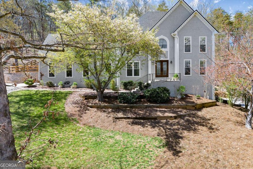 Located in the highly sought-after Lassiter school district, this Highland Pointe home features an oversized owner's suite and a finished terrace level with tray ceilings, fireplace, wet bar, mini kitchen, and guest bedroom-ideal for entertaining or extended stays. The owners have invested over $100K to create a partially leveled flat backyard framed by two custom-built stone retaining walls, a fenced area with three access gates, flat ceilings throughout, smart systems, and core infrastructure improvements. These thoughtful upgrades deliver both modern comfort and long-term peace of mind.