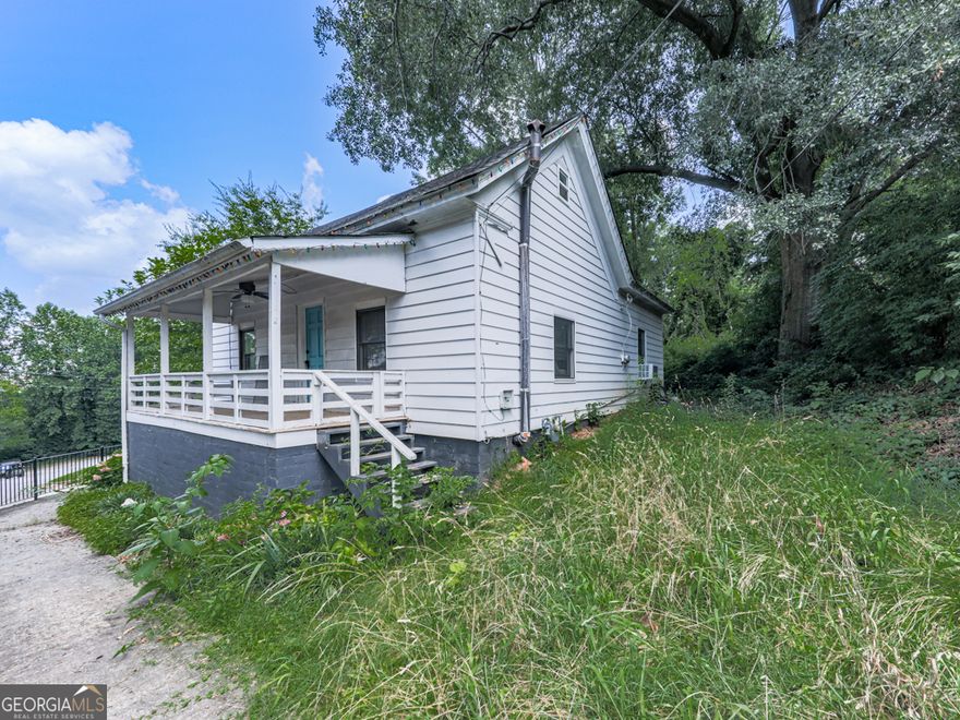 Welcome to this 23 Riverdale Cir - This  cute  white cottage is nestled in the heart of downtown Canton! Bursting with character and curb appeal, this 2-bedroom, 1-bath home offers approximately 900 square feet of comfortable living space-perfect for first-time buyers, owner-occupants, or investors looking for a rental opportunity.  Step onto the rocking chair front porch and enjoy your morning coffee or unwind in the evenings as you take in the charm of the neighborhood. Inside, you'll find a cozy layout with generously sized bedrooms and classic cottage details. The walkable crawlspace offers added storage or easy access for maintenance. The home also features its own private driveway and sidewalk, adding to its convenience and accessibility.  Located just minutes from all the shopping, dining, and entertainment downtown Canton has to offer, this home is also close to Riverstone Parkway, I-575, Mill on Etowah, Northside Hospital, and more. Whether you're looking for walkability, a convenient commute, or a quaint place to call home, this one checks all the boxes!  Don't miss this rare opportunity to own a piece of downtown Canton charm!