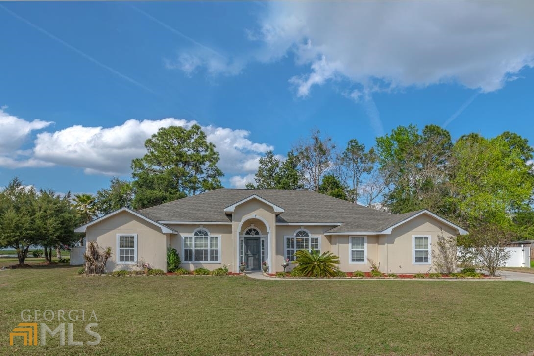 FOUR BEDROOM HOME WITH A BONUS ROOM ON A LARGE LOT IN LAKE MANOR! THE LIVING AREA BOASTS WOOD FLOORING AND 10’ CEILINGS WITH A FORMAL DINING ROOM. THE UPDATED KITCHEN OFFERS A BREAKFAST BAR & NOOK AS WELL AS A WI-FI ENABLED CONVECTION RANGE. THE SPLIT PLAN FEATURES A NICELY APPOINTED PRIMARY BEDROOM SUITE THAT IS COMPLETE WITH A CORNER SOAKING TUB & SEPARATE SHOWER AS WELL AS A SPACIOUS WALK-IN CLOSET. THE EXTERIOR IS CONSTRUCTED OF LOW-MAINTENANCE CONCRETE SIDING AND INCLUDES A 4 YEAR OLD ARCHITECTURAL SHINGLE ROOF. THERE’S PLENTY OF ROOM IN THE PRIVACY FENCED BACKYARD WITH A DECK AND SCREENED LANAI. DON’T MISS THE BRAND NEW HVAC SYSTEM WITH TRANSFERRABLE WARRANTY. OTHER NOTABLE FEATURES ARE AN INDOOR LAUNDRY ROOM, FRESH PAINT, NEW CARPET, AND AN IRRIGATION SYSTEM. LAKE MANOR IS LOCATED IN WALKING DISTANCE TO ALL SCHOOLS, INCLUDING THE COLLEGE OF COASTAL GEORGIA. JUST TWO MILES FROM I-95, THIS HOME IS GREAT FOR BRUNSWICK OR JACKSONVILLE COMMUTERS. ALSO CONVENIENT TO AN ARRAY OF SHOPPING & DINING. MAKE AN APPOINTMENT TODAY!