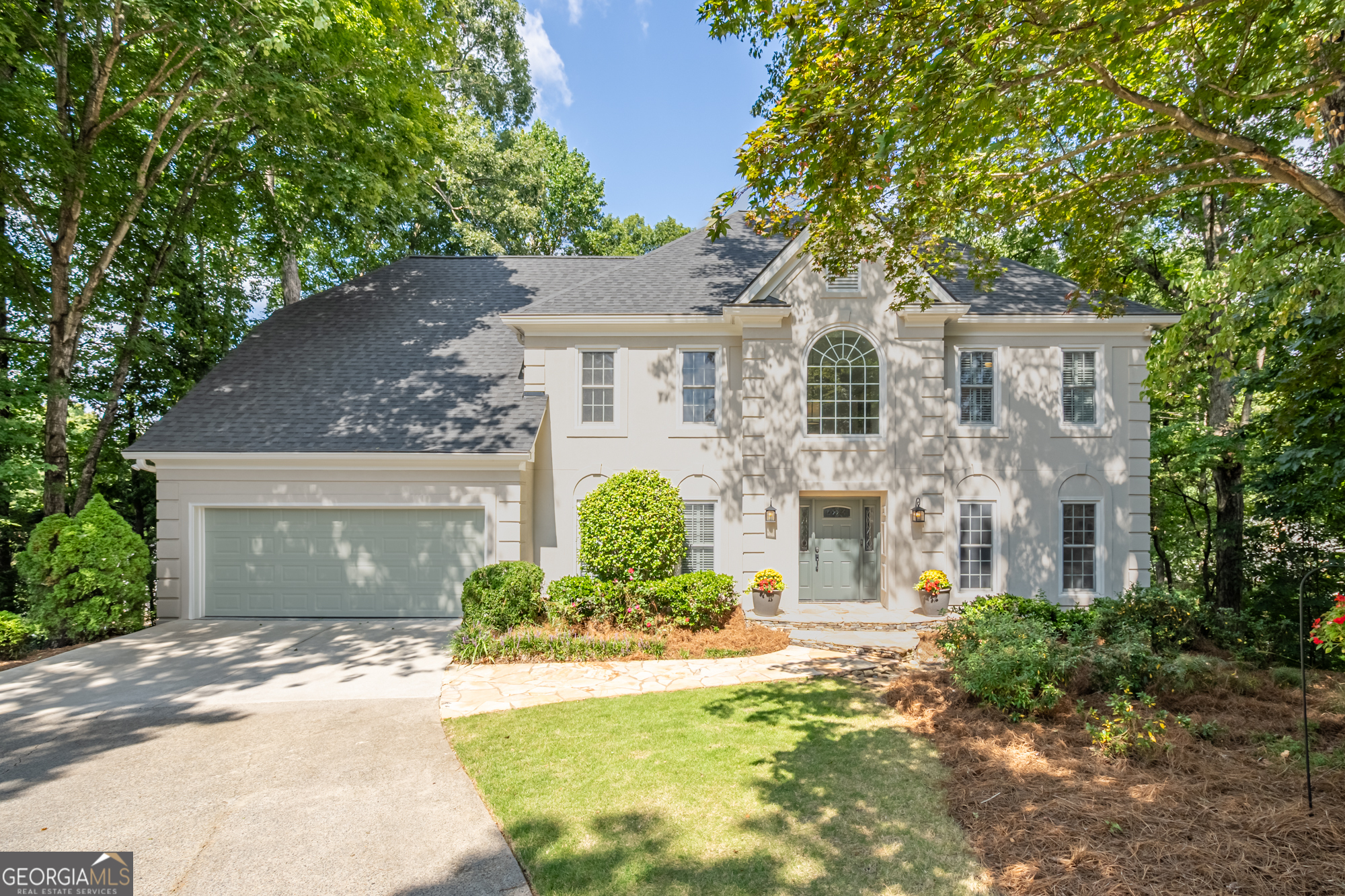 Discover your dream lifestyle in coveted Camden Place! This exceptional home is set on a private cul-de-sac in one of East Cobb's most desirable executive neighborhoods with award-winning schools and resort-style amenities of pool, tennis, and clubhouse. The showstopper is a dramatic sunroom-a unique space that flows seamlessly from the gourmet kitchen and soaring 2-story family room with 20-foot ceilings. The kitchen features granite counters, Wolf gas cooktop with 22,000 BTU wok burner and professional vented hood, built-in wine fridge, and breakfast area. A main level bedroom with custom built-ins doubles as an ideal work-from-home office with direct deck access for fresh air breaks. Upstairs, the owner's suite offers a sitting room, two large walk-in closets, a renovated spa bath with dual vanities, oversized shower, and soaking tub. The secondary bedrooms share a spacious Jack-and-Jill bath. The terrace level boasts a private movie theater, kitchenette, and workshop, full bath, plus a terrace-level bedroom with direct access to a covered, secluded hot tub deck that feels like a private spa. Outdoor living continues with multiple decks for great entertaining areas, covered patio, and a landscaped, fenced yard. NEW roof! Everyday conveniences include a large laundry room and extra fridge off the garage entry. Minutes to East Cobb and Historic Roswell dining, shopping, and the Chattahoochee River's parks and trails