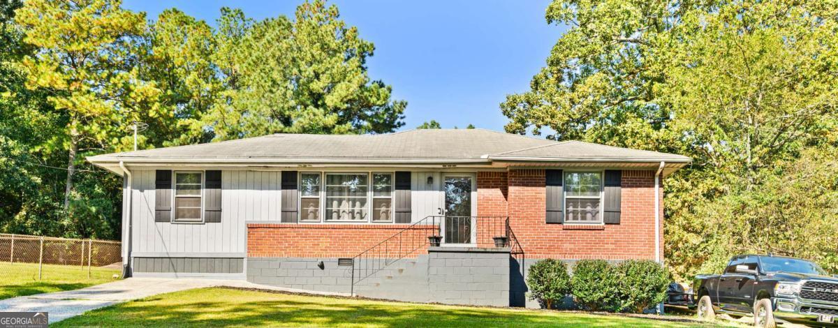 Cozy Living in Lithia Springs! This charming 3-bedroom, 1-bath home is filled with natural light, making every space feel warm and inviting. A bright sunroom is the perfect spot for morning coffee or evening relaxation. The primary bedroom is separated from the secondary bedrooms, offering a private retreat while keeping the home functional and cozy. An outbuilding with power provides extra storage or a great setup for hobbies, a workshop, or creative projects. Whether you're a first-time buyer, downsizing, or looking for an investment, this home is full of opportunity. Conveniently located near shopping, dining, and major highways in Lithia Springs.