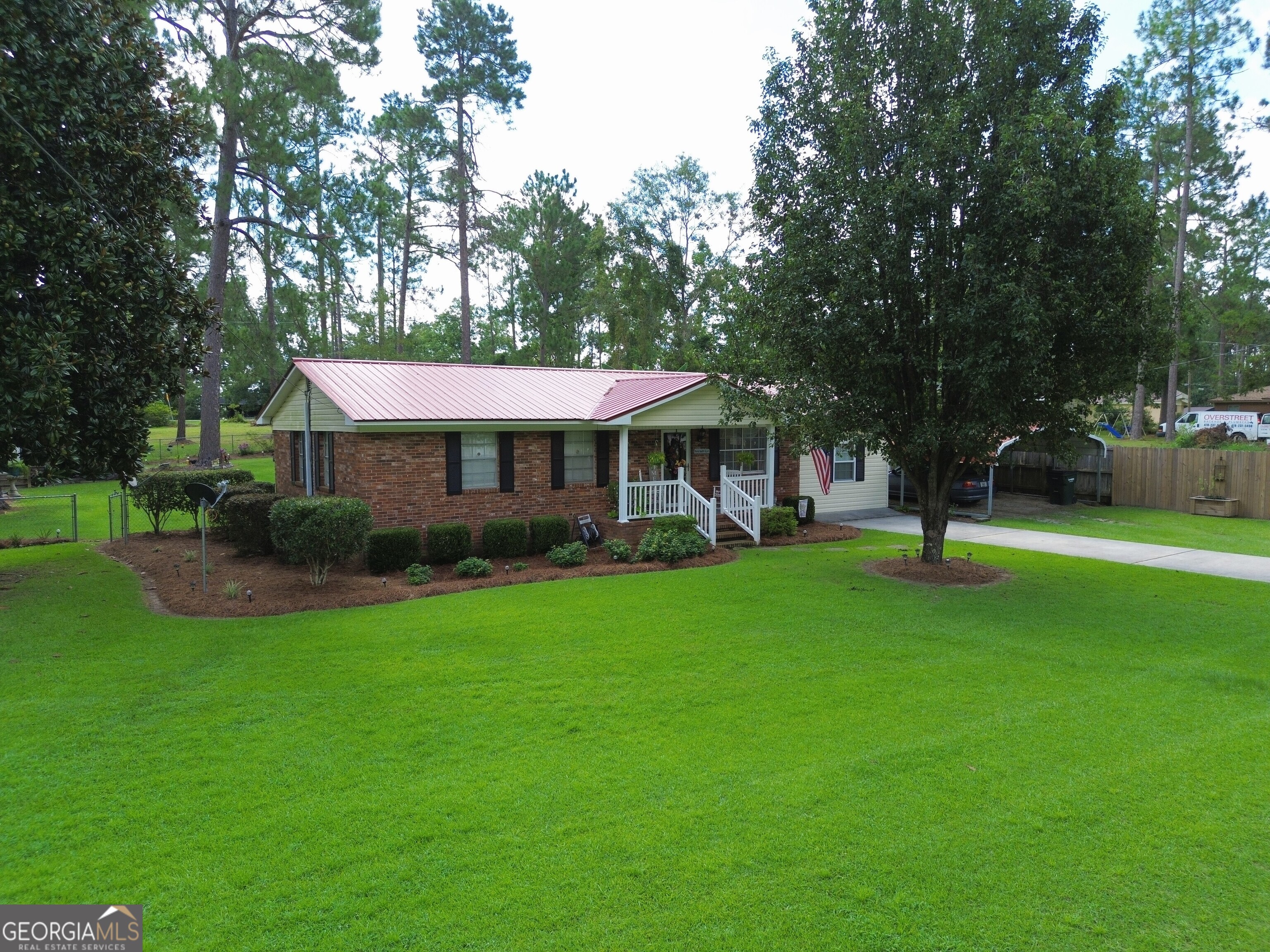 This 4-bedroom, 2-bath home offers peaceful living just outside the city limits of Swainsboro, GA, with the convenience of city water. It features an attached carport and a large, fenced-in backyard with a covered back porch-perfect for relaxing or entertaining. It also has a storage building in the backyard with an attached greenhouse for plants and gardening. One of the bedrooms has its own separate entrance, offering extra privacy. A privacy fence separates the home from the adjoining neighbor, and the quiet neighborhood is just minutes from town. The home also includes a durable 3-year-old metal roof for added value and peace of mind.