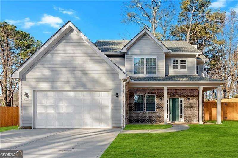 LOCATION, LOCATION, LOCATION!! Welcome to your dream home! This exquisite new construction is ideally situated in the heart of Douglasville. Just steps from a wide array of shopping, dining, and entertainment options, and with easy access to I-20, everything you need is right at your fingertips. As you step inside, you'll be greeted by an inviting foyer that leads to an elegant formal dining room, perfect for hosting guests. The open-concept kitchen and living area create a seamless flow. Turn on the cozy fireplace with the flip of a switch! The chef-inspired kitchen boasts sleek quartz countertops, an island for extra space, and Samsung stainless steel appliances. Upstairs, you'll find 4 spacious and sunny bedrooms, including the luxurious primary suite. This private retreat features his & her closets, double vanity, spa-like soaking tub, and a beautifully tiled walk-in shower. Outside, the nearly half-acre corner lot is fully fenced with gorgeous cedar wood, providing ample greenspace and endless possibilities for outdoor living & entertaining. This beautifully crafted home is brand new and ready for you to make it your own. Don't miss out on this incredible opportunity to live in modern luxury with the perfect combination of location and style!