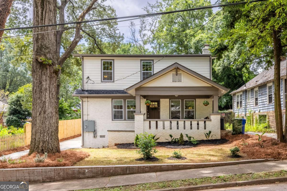 Expanded 1930s craftsman perched on a quiet lot in Sylvan Hills. This home lives large--5 bedrooms, 4.5 baths, and 2 primary suites with over 3300 square feet of living space. A quintessentially southern front porch overlooks Burns Drive, a quiet street in Sylvan Hills dotted with historic homes and shady trees. Inside, you'll find a blend of historic charm and modern updates--coffered ceilings, built-in bookshelves, and a fireside living room with gas fireplace. The kitchen is the heart of the home--a breakfast bar is the perfect spot for busy mornings, and ample tasking space and double ovens make hosting a breeze. French press? Espresso machine? Pourover? All three? This spacious kitchen has room to accommodate your caffeine intake ritual and then some--a dedicated butler's pantry has additional cabinet space, shelving, and beverage cooler. A separate walk-in pantry offers plenty of room for your Costco and Dekalb Farmer's Market hauls, which brings us to the dining room--it's time to brush up on your cooking, because you'll be hosting holidays from now on! The generous dining room comfortably fits everyone, so you'll be able to celebrate milestones and be within earshot of all of the gossip--no need for the awkward kids table in a separate room. Off the kitchen, a big laundry room and mudroom with built-in storage offers maximum convenience, along with a powder room for guests. On the main, the first primary suite has a walk-in closet and roomy tiled bath with double vanity and rainhead shower. Upstairs, a second primary suite also has a large walk-in closet and spacious tiled bath with double vanity and water closet. A third (yes, third!) ensuite is off the upstairs hall, and two additional bedrooms and hall bath round out the upstairs. This home is set on a large lot--over 150 feet deep. The peaceful backyard has a freshly stained deck perfect for entertaining. In the back of the yard, a poured concrete pad flanked by 3 walls is the ideal spot for a fire pit and Adirondack chairs, future greenhouse, or studio. Savvy buyers, the current owner doesn't have the history of the back structure, but based on the terracotta mosaic patio and poured concrete, it was most likely an accessory dwelling of some kind. Sylvan Hills is a sweet community of historic homes on Atlanta's westside. Only a couple of blocks from verdant Perkerson Park, easy access to Tyler Perry studios and the continuously expanding Fort Mac, and a few short blocks to the exploding development along the westside Beltline. Ask about our rate buydown!