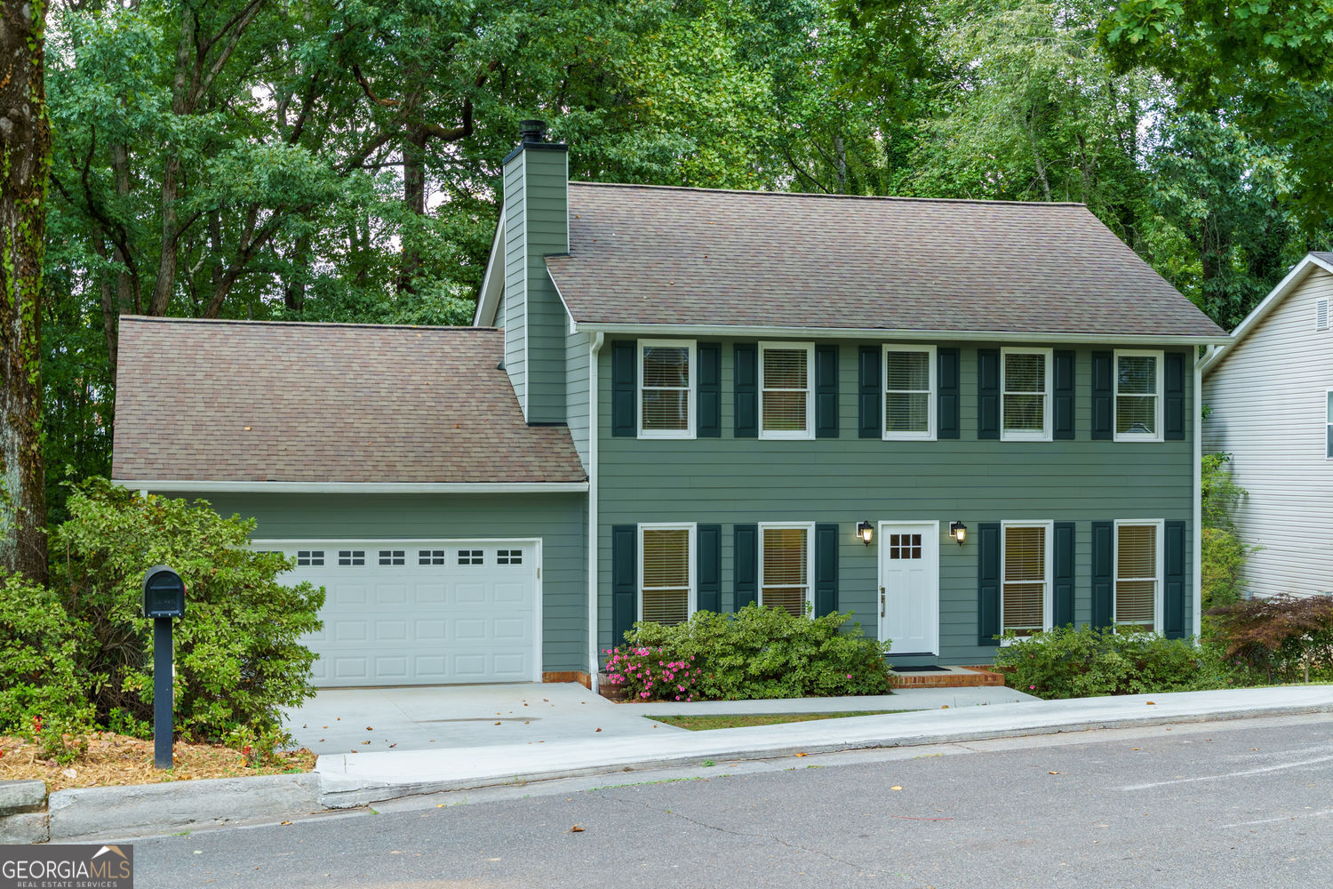 Charming upgraded colonial with NO HOA in prime Roswell location! Welcome to this beautifully well maintained Three Bed, Two and a Half Bath ~ Two Story home with partially finished basement in a peaceful tree lined setting, just minutes from everything Roswell has to offer. Perfectly combining classic charm with modern upgrades, this home offers comfortable living both indoors and out. Step inside to find a spacious living room featuring a cozy fireplace and a built in wet bar, ideal for entertaining guests or just relaxing, along with a convenient half bath and a beautifully upgraded kitchen and laundry/mud room that extends into a separate dining room with a big picture window and spacious family room. Upstairs, you'll find three generously sized bedrooms, including a primary suite with master bath, double vanities and his and hers closets, along with a second full bath that serves the other two bedrooms. The partially finished basement includes an oversized versatile bonus room that can be transformed into a home gym, craft studio, teen retreat or playroom. The heart of the home extends outdoors with a newly built, double deck, perfect for outdoor entertaining or quiet mornings with a cup of coffee. Located in a tranquil neighborhood but close to top rated schools, shopping, dining and beautiful parks, this home offers the best of both worlds- peace and privacy, without sacrificing convenience. Don't miss your opportunity to own this move in ready gem in sought after Roswell!