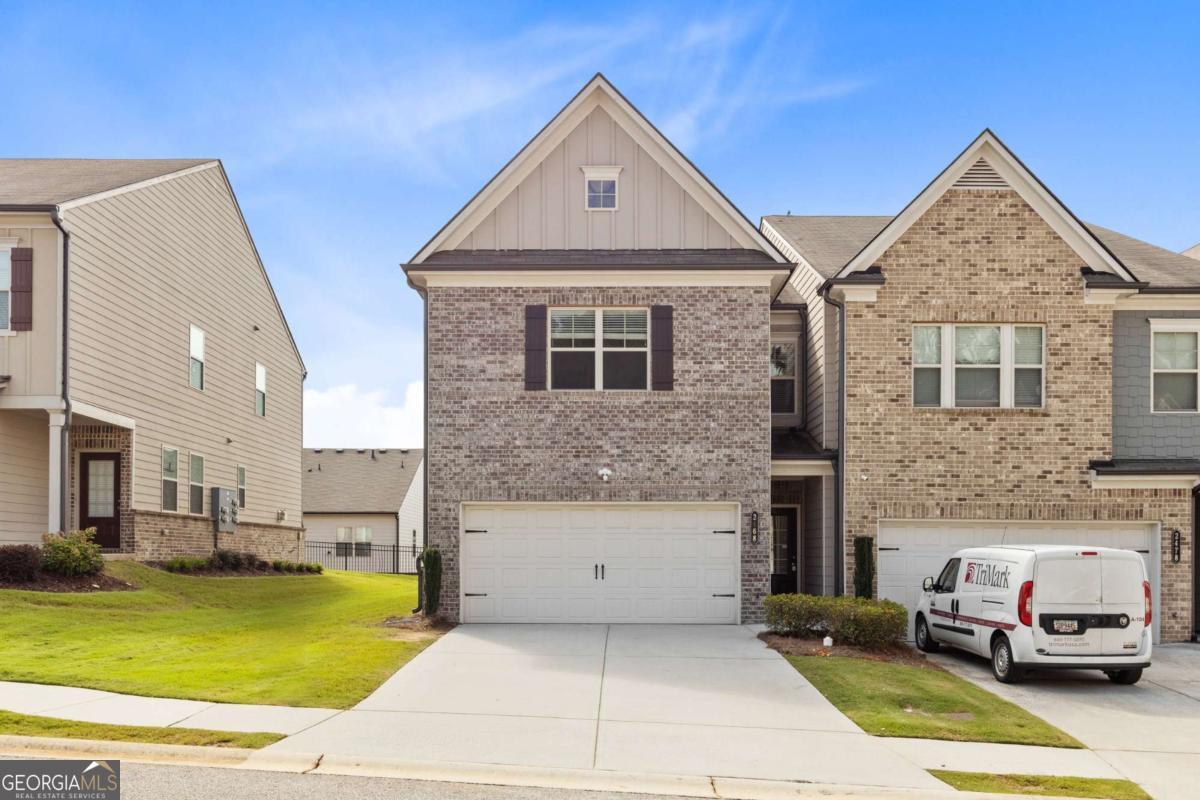Stylish End-Unit Townhome with Spacious Yard This beautifully maintained 3-bedroom, 2.5-bath townhome with a 2-car garage is move-in ready and full of upgrades. The main level features hardwood floors, fresh paint, and an open floor plan that seamlessly connects the great room-to the dining area and chef's kitchen. The kitchen offers granite countertops, stainless steel appliances, and a center island perfect for casual dining. Upstairs, the owner's suite impresses with a walk-in closet and a spa-inspired bath showcasing a frameless glass shower and elegant ceramic tile. Two additional bedrooms, a full bath, and a convenient laundry room , washer and dryer included provide plenty of space for everyday living. Set on one of the largest lots in the community, this home offers extra outdoor space rarely found in townhomes. Ideally located near shops, restaurants, and excellent schools. ?? A perfect blend of comfort, style, and convenience-schedule your private tour today!