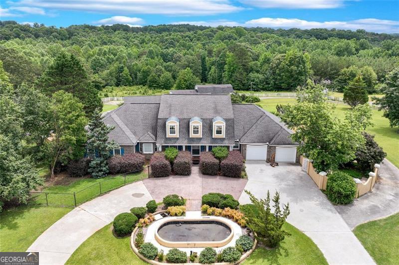 Nestled on 11.92 acres, this estate offers privacy & space just minutes from downtown Toccoa & I-85! The centerpiece of the property is a 5,828 sqft brick home, thoughtfully designed for comfort and elegance. Step inside to find expansive living spaces, high ceilings, an open concept kitchen, dining & living area, multiple fireplaces, and plenty of room for entertaining or relaxing. Upstairs you'll find ample space for storage or bonus rooms. The basement includes a full kitchen, bathroom, living area & extra room for flex space. Outdoors, enjoy an in-ground swimming pool, complete with a pool house-perfect for summer gatherings. Car enthusiasts or hobbyists will love the 2,250 sqft garage, while the impressive 3,220 sqft barn offers endless possibilities for storage or livestock use. The property also features fenced pastureland, ideal for horses or livestock, and a meandering creek that adds to the natural beauty of the setting. Whether you're looking for a private estate, a working mini-farm, or a countryside escape, 701 Sunshine Road has it all!