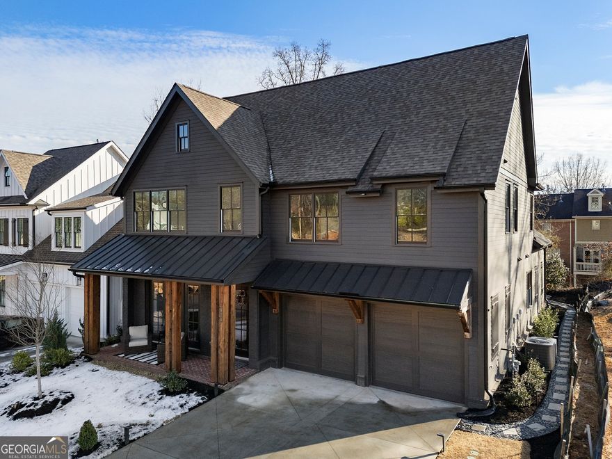 Discover this beautifully priced home nestled within a meticulously landscaped, secure gated community, perfectly located near both Marietta Square and Kennesaw Mountain. Enjoy unparalleled access to miles of scenic hiking and biking trails just steps from your front door, along with a delightful selection of nearby restaurants and shops.    This stunning floor plan is thoughtfully positioned on an inviting lot near the community entrance. The interior boasts a primary bedroom suite on the main level, featuring a luxurious en-suite bathroom complete with a freestanding tub, an adjacent laundry room for added convenience, and a well-designed mudroom. The designer kitchen showcases top-of-the-line Jenn-Air appliances, exquisite countertops, elegant painted cabinets with soft-close drawers and doors extending to the ceiling, complemented by an impressive trim package. Beautiful hardwood floors enhance the main level and upstairs hallway for a touch of refined elegance.    Upstairs features spacious secondary bedrooms paired with an exceptional entertainment roomCoperfect for family gatherings and entertaining friends.    Step outside to relax on the covered back porch that includes an outdoor fireplaceCoideal for cozy evenings or cheering on your favorite sports team (with a conveniently placed outlet above). The community also boasts a central park equipped with a fenced-in dog park and fire pit, offering countless opportunities to connect with neighbors. Plus, enjoy the ease of maintenance-free living with lawn care provided by the HOA for your convenience.    Don't miss out on this incredible opportunity!