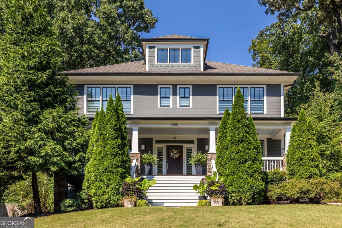 Perched on a gentle rise in the Decatur neighborhood of Midway Woods, this modern four-square craftsman built in 2016 brings together timeless curb appeal and thoughtful design. The wide, welcoming front porch looks out over the neighborhood, and inside you'll find a light-filled home that is open and inviting-perfect for entertaining. Site-finished hardwood floors run throughout, tying together spacious rooms and a layout made for everyday living. The kitchen is the heart of the home, and this one is truly oversized. A central island large enough to gather around anchors the space, surrounded by abundant custom cabinetry, GE Profile appliances, quartz countertops, and plenty of work surfaces. A butler's pantry with a wet bar connects the kitchen to the dining room, providing function and a touch of formality. The living room features coffered ceilings, a central gas fireplace, and custom built-ins making it the natural gathering spot. Every bedroom in this home has its own ensuite bathroom with custom tile work, offering unmatched privacy and comfort for family and guests alike. The downstairs suite is especially versatile, with a closet large enough that the current owners call it their "cl-office." Upstairs, there are four spacious bedrooms and a bright laundry room large enough for two sets of washers and dryers. The primary suite spans an impressive footprint and feels like its own sanctuary. The primary bath is designed for indulgence with an oversized freestanding soaking tub, double vanities, and a walk-in shower complete with multiple rain heads. The owners have invested in thoughtful updates that keep the home fresh and ready for its next chapter. Both the interior and exterior of the home feature fresh, designer Benjamin Moore paint and deck stain. Custom plantation shutters and draperies have been installed throughout the first floor and across all front-facing windows upstairs, adding both beauty and privacy. Out back, a coveted covered deck extends your living space into the outdoors, perfect for enjoying a morning coffee or an evening dinner. A separate two-car garage with unfinished attic space provides both storage and convenience. The professionally landscaped lot itself is beautifully situated on a quiet, tree-lined dead-end street, providing the home with a sense of privacy while still being part of an active community with wonderful neighbors. With a location just outside the city limits of Decatur, the home offers lower taxes without sacrificing optimal access to Decatur's prized amenities-restaurants, shops, and festivals, to name a few. This is the kind of home where life unfolds with ease. Spacious, comfortable, and beautifully located in one of Decatur's most beloved neighborhoods.