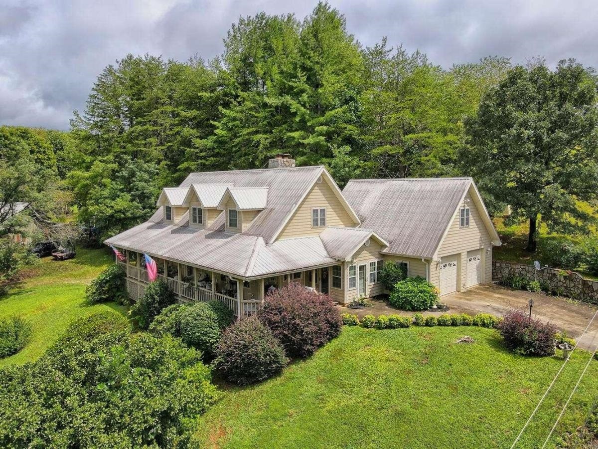 Charming Country Farmhouse nestled in the foothills of the Appalachian mountains surrounded by hiking trails, waterfalls and vineyards. Beautiful stone gas fireplace in family room with built-in shelving and high ceilings on all 3 floors. Spacious kitchen w white cabinets, pantry & breakfast area that opens to a refreshing sunroom. Oversized wrap-around deck with views to long-range mountains. Master on Main, Jetted Tub, and several walk-in closet and 2 car garage on main level. 2nd floor includes 2 bedrooms & full bath plus sitting area. Huge unfinished open basement with stone fireplace and finished bath has a separate over-sized 3rd garage plus workshop area. Additional unfinished bonus room over garage. This is home has so much room to grow - finished area of 2365sqft yet you can add to its charm and should you 'finish' the basement and bonus room this home will be over 4000sqft! Enjoy the serenity of nature that this home offers.