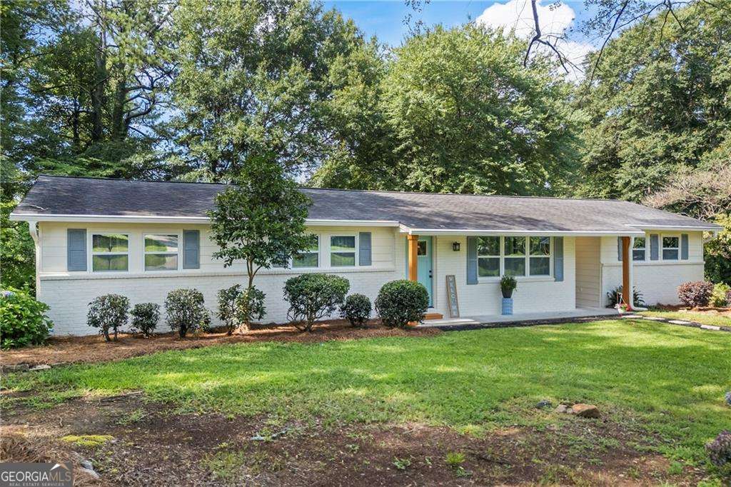 Welcome to this beautifully remodeled home nestled in a highly desirable Smyrna neighborhood. Situated on a premium corner lot, this property has been transformed into a true dream home with no detail overlooked. As you step inside, you're welcomed by brand new floors, modern accent walls, and a seamless open-concept layout that flows effortlessly from the spacious family room into the stunning kitchen. Designed with both style and function in mind, the kitchen features floor-to-ceiling tile backsplash, sleek white soft-close cabinets, abundant granite countertops, and a custom island with butcher block ends-perfect for all your cooking and entertaining needs. Just off the kitchen, a large bedroom with a walk-in closet offers incredible versatility, whether as an in-law suite, guest room, office, or playroom. The home features two front entrances and ample storage throughout. With three spacious bedrooms and two fully updated bathrooms, every inch of this home has been thoughtfully designed. The expansive master suite combines two former rooms to create a luxurious retreat, complete with a private back door that leads to a porch with a built-in Jacuzzi-your own personal oasis. Recent upgrades include brand new HVAC and ductwork, new plumbing and electrical, new energy-efficient windows, fresh paint inside and out, and recessed dimmable lighting with a retractable fan. A custom media nook keeps wires hidden for a sleek, polished look, and the newly built laundry room adds even more functionality. Located near major highways, top-rated schools, and popular shopping and dining, this home offers the feel of new construction without the high price tag. Don't miss your chance to own this exceptional property-schedule your private showing today!