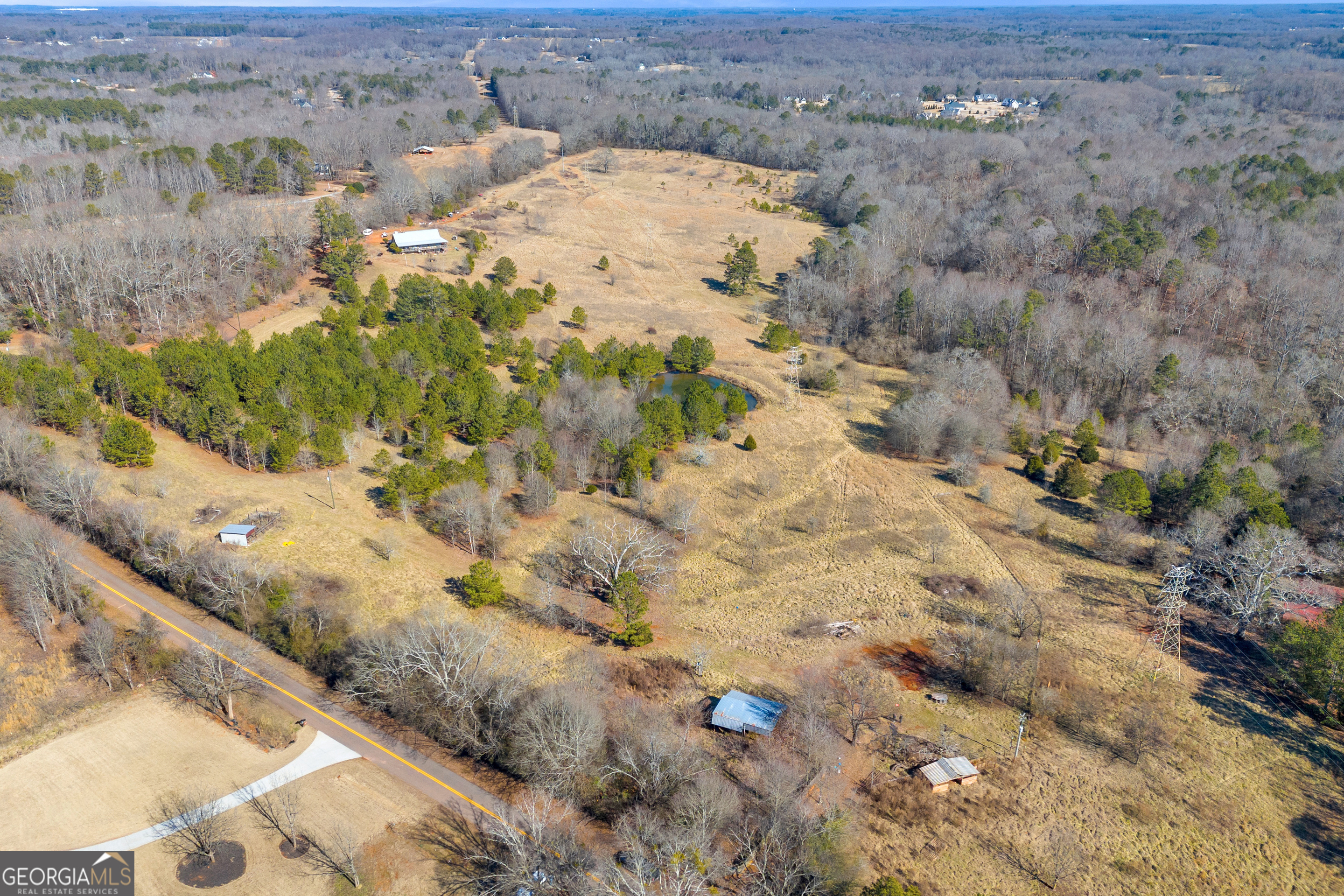49+/- Acres of Beautiful Pasture with Two Ponds, Barn, and Creek Frontage. This stunning 49+/- acre property is a rare find! With mostly open pasture and a mix of wooded areas, it offers endless possibilities for farming, your dream home, or even a family compound. The property is fully fenced, making it ideal for livestock, and features two ponds perfect for fishing or watering your animals. You'll also find a small stable, a pole barn, and a chicken coop already in place, making this property ready for your agricultural needs. The land borders Cedar Creek, adding to its natural beauty and providing a peaceful, serene setting. For those looking to expand, there is an additional 47+/- acres available next door, bringing the total to just shy of 100 acres-giving you even more room to grow! Be sure to ask about this opportunity! While there is a power line easement across the property, it does not detract from the stunning view of the rolling pasture. Plus, the location is just a short drive to both Atlanta and Athens, offering the perfect balance of privacy and convenience. Don't miss out on this incredible opportunity to own a piece of beautiful, versatile land!
