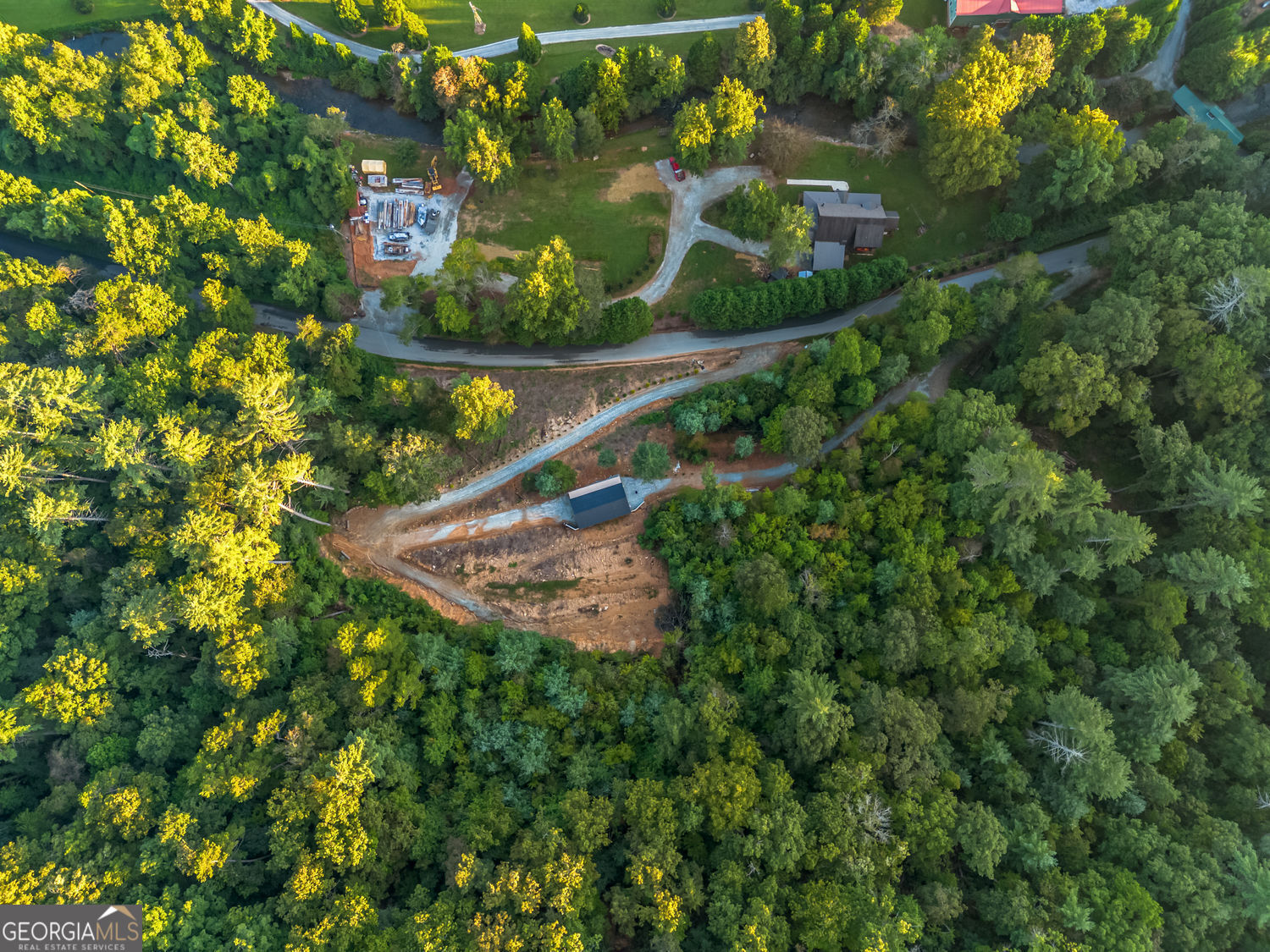 9.3 acres of UNRESTRICTED land in Rabun County...no deed restrictions. Two lots have been cleared and created to build two homes. A beautiful lot overlooking Stekoa Creek. You can hear the year-round running creek from the property. There is a seasonal view of a waterfall. There is a waterfall on the property near the lower level building site. A beautiful and spacious permitted RV Camper/Workshop has been build to accommodate an RV and workshop. The spacious workshop has water, septic, electricity, washer/dryer hookup and fiber optic internet. Create your own family compound...a home for you and a home for guests. And for those friends who want to bring their RV, they too have a place to park and enjoy the beauty of Rabun county. There are two driveways to enter the property. The first leads to the lower lot near the waterfall. The seond driveway is higher on the mountain and has a switchback to access the build site. The RV Camper/Workshop is situated between the two sites. Let your imagination run wild with the possibilities this lot affords. AND it's not far from 441 and access to Clayton's shops and restaurants.