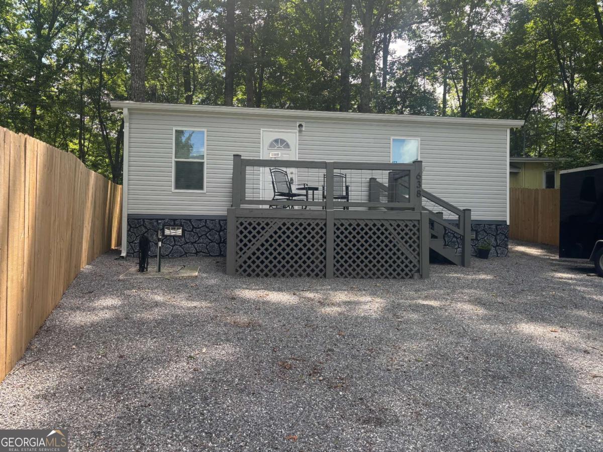 Furnished 1-bedroom, 1-bath home in Bald Mountain Park with year-round mountain views. The property includes 0.13 unrestricted acres, improved with a 2021 Clayton mobile home with views of Brasstown Bald. The home has a nice front porch to enjoy those views. The interior features an open-concept living, dining, and kitchen. There is excellent natural light, luxury vinyl flooring throughout, and a spacious primary bedroom with a full bath. The rear porch leads to the backyard with a firepit area and a 6x8 storage shed/workshop. The property is partially fenced. There is about 30 feet of additional property behind the fencing. There is little maintenance, with no grass to mow, vinyl siding for easy cleaning, and plenty of parking in the gravel driveway. Minutes to local retailers and restaurants of Hiawassee and beautiful Lake Chatuge.