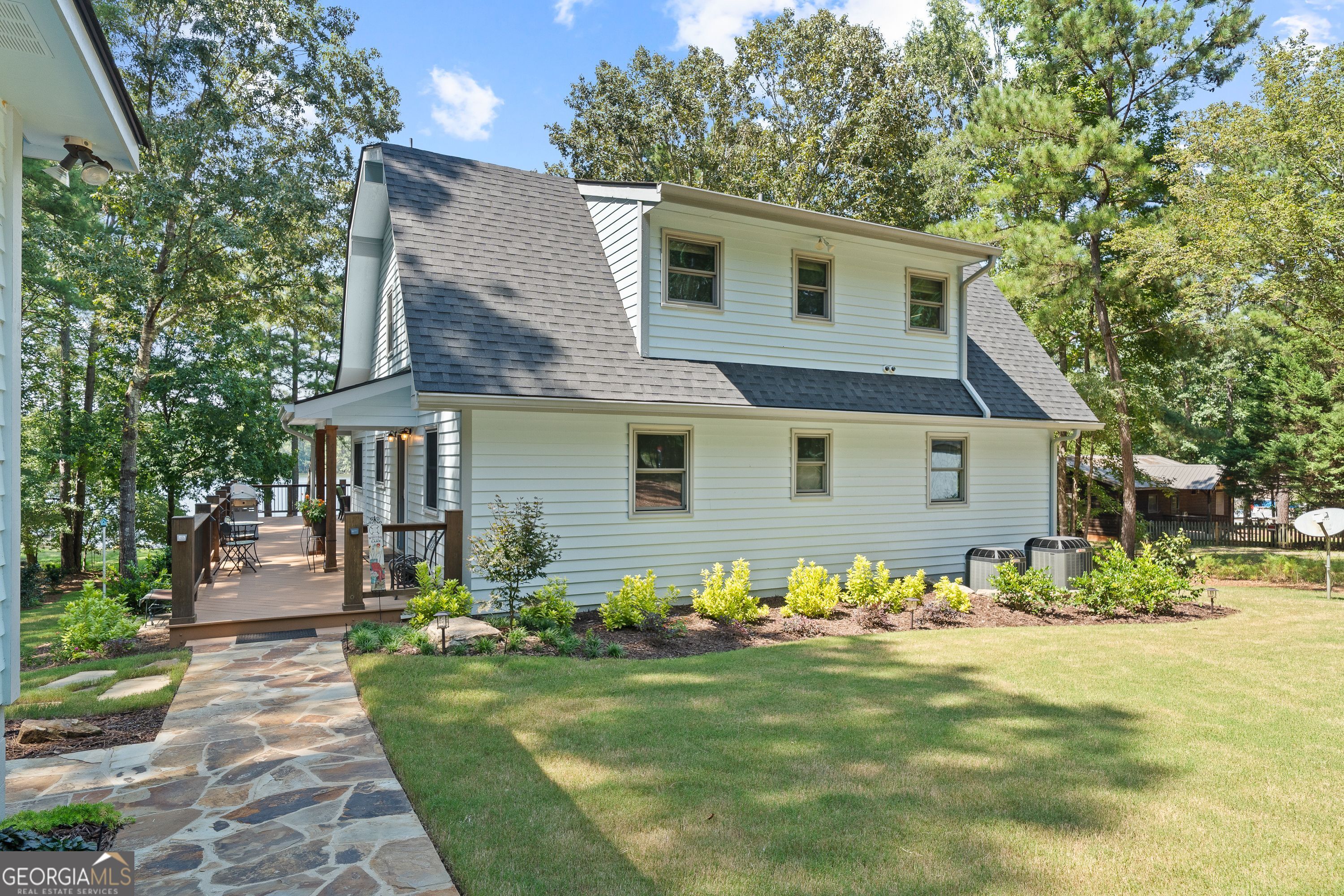IMMACULATELY RENOVATED MAIN LAKE HOME! Hard to find move-in-ready property on the prettiest part of Lake Oconee (Richland side) with gorgeous main lake views and private max dock. Beautiful, wooded setting with detached 2-car garage, wrap around porch with covered entry and full-length deck facing the lake. Open floor plan with LVP flooring, kitchen with granite countertops and high-end stainless-steel appliances, vaulted, tongue-groove living room with stone fireplace and large sunroom. Two bedrooms with bathroom on the main floor. Loft area upstairs with master bedrooms suite and luxurious bathroom. The perfect lake property waiting to make you memories!