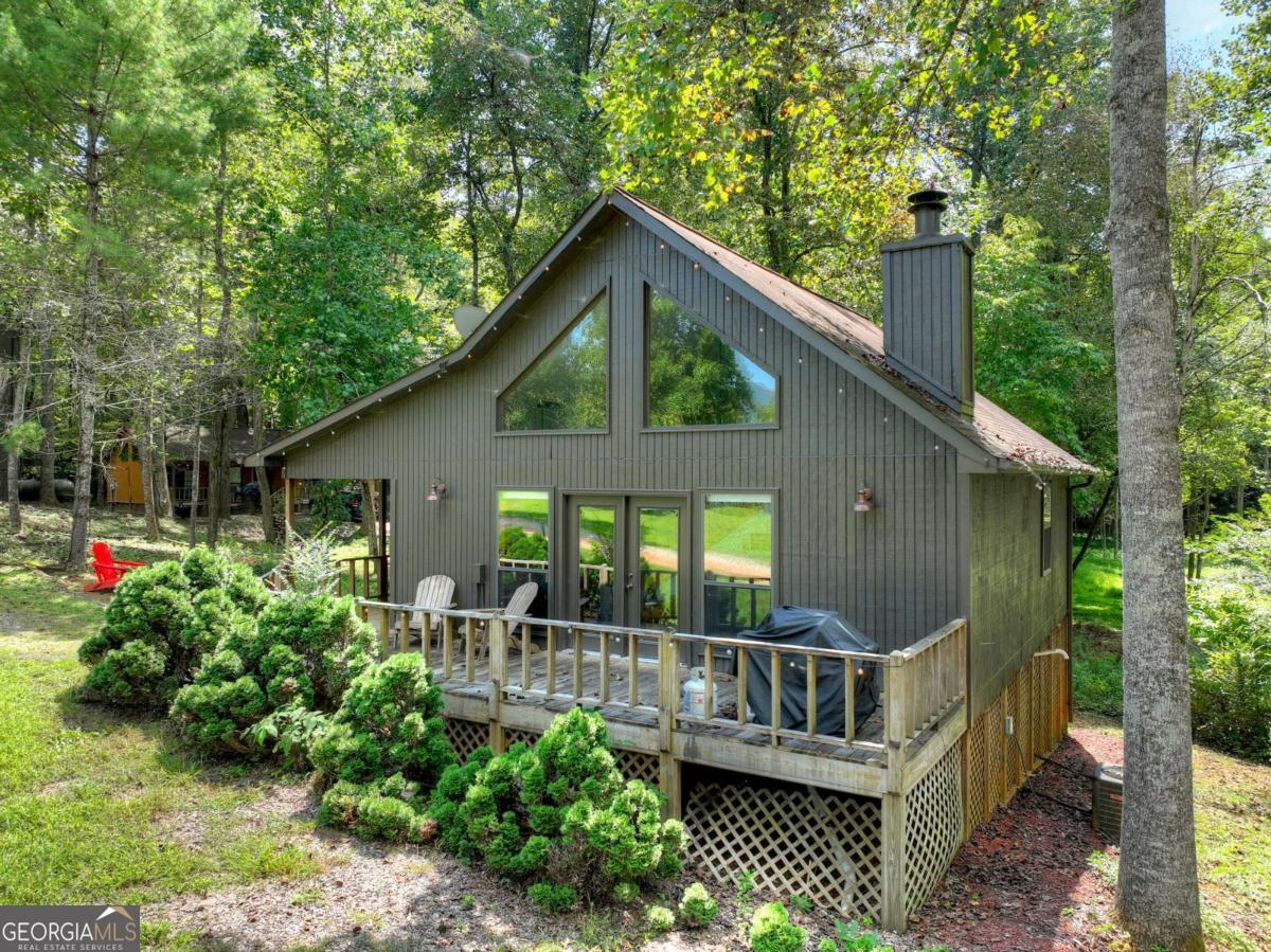 Perched atop nearly seven acres of rolling North Georgia terrain, Alpine Way presents a rare and undiscovered commercial opportunity-an established cabin compound with year-round mountain views and endless potential. Designed as a boutique enclave, the property currently consists of eight distinct cabins plus a community pavilion and laundry facility, each thoughtfully placed to maximize privacy, views, and guest experience. The six one-bedroom, one-bathroom cabins are complete with full kitchens, inviting living rooms, fireplaces, and covered outdoor decks-ideal for cozy retreats. The seventh cabin offers two bedrooms and two bathrooms, along with generous outdoor space, while the final cabin stands as a true flagship: two bedrooms, two and a half bathrooms, a basement den, office, and dual fireplaces, perfect for extended stays or owner's quarters. Every cabin is independently serviced with its own septic system and power meter, offering both autonomy and scalability. The community pavilion and laundry facility serve as a natural hub, yet with imagination could be reimagined into a pool and spa deck, fitness or wellness center, or event pavilion, further elevating the guest experience. With infrastructure in place, room for additional amenities, and expansion possibilities across the acreage, Alpine Way is positioned to become a cash-flow powerhouse-whether as a boutique BNB retreat, corporate getaway, or private family compound. Conveniently located minutes from Vogel State Park, Brasstown Bald, Butternut Creek Golf Course, Lake Nottely, and Downtown Blairsville, with Helen and Blue Ridge nearby, this property merges seclusion with accessibility. Alpine Way is more than real estate-it's a vision of lifestyle and legacy with both immediate income and long-term growth potential.