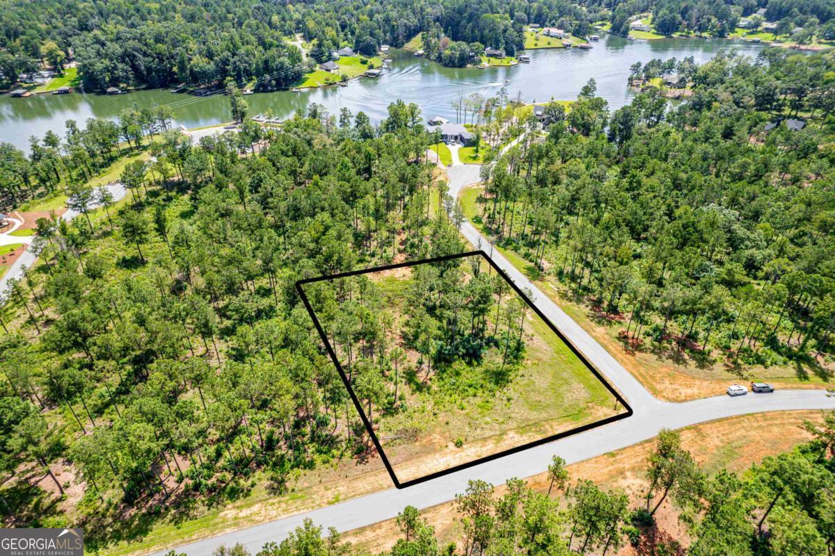 Build Your Dream Lake Getaway at The Falls at Lake Sinclair. Experience the ideal combination of community amenities and lake living with this 1.02-acre interior corner lot located in the desirable gated neighborhood of The Falls at Lake Sinclair. This prime lot offers an assigned slip at the community dock, just a short walk from your future doorstep-making lake days effortless and accessible. Enjoy an array of upscale amenities including a resort-style pool, pavilion with outdoor fireplace, putting greens, and a private boat ramp-all designed for relaxation and recreation. Whether you're planning a full-time residence or a weekend retreat, this property offers the ideal setting. Conveniently located just 15 minutes from downtown Milledgeville, you'll have quick access to shopping, dining, and entertainment, all while enjoying the peaceful lifestyle that Lake Sinclair offers. Don't miss this opportunity to invest in one of the area's newest premier lake communities!