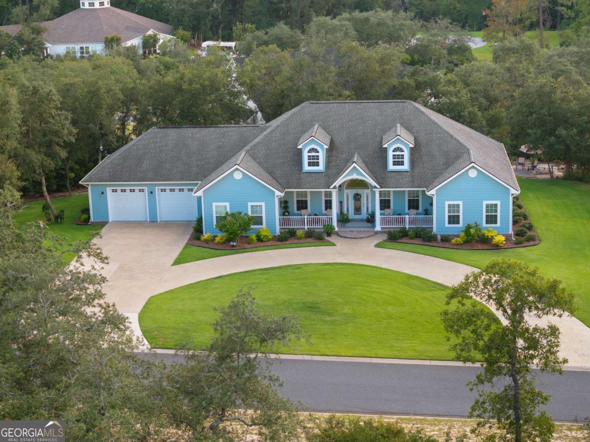 Welcome to Bluffs of the Satilla! This stunning 3 bed, 2.5 bath custom home (built 2018) offers nearly 2,700 sq. ft. of stylish living in a gated community with a pool, pool house, and river boardwalk. Inside you'll find 10 ft ceilings throughout, LVP flooring, and an oversized kitchen with custom cabinets, stainless appliances, solid-surface counters, and a large island-perfect for entertaining. The spacious primary suite boasts walk-in closets, a soaker tub, tiled shower, and double vanity. Enjoy relaxing on the covered back deck, by the stone patio, or in the beautifully landscaped yard with an irrigation system. Energy-efficient foam insulation, 3-zone HVAC, and an oversized 2-car garage complete this must-see home!