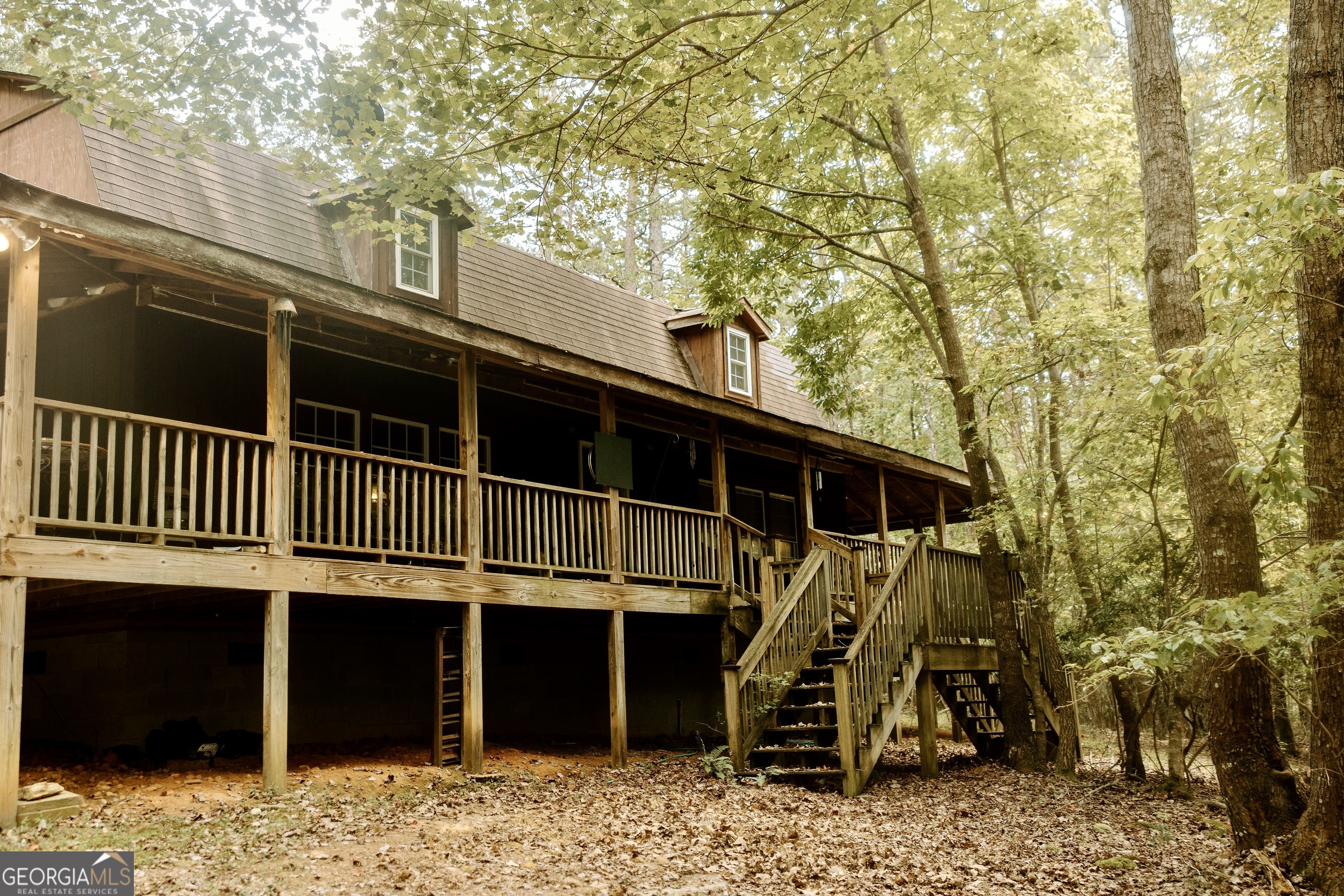 Surrounded by nature, this charming 3-bedroom, 2-bath waterfront home is nestled on 1.77+/- private acres offering the perfect balance of peaceful seclusion and convenient access to Cleveland, Helen, and Habersham. The main level features an open kitchen, dining, and living area with a cozy gas log fireplace, a walk-in pantry, and a spacious primary suite. The primary bath connects to the laundry room, which also opens outdoors for convenient clean-up after enjoying time outside. Upstairs, you'll find two generously sized bedrooms and a full bath-perfect for family, guests, or even a home office. A wraparound porch surrounds the home, providing the perfect spot to relax and take in the quiet, private setting. Don't forget the 2 outbuilding that offer great storage storage or a work space. Whether you're looking for a year-round home or a weekend retreat, this property offers the best of North Georgia living.