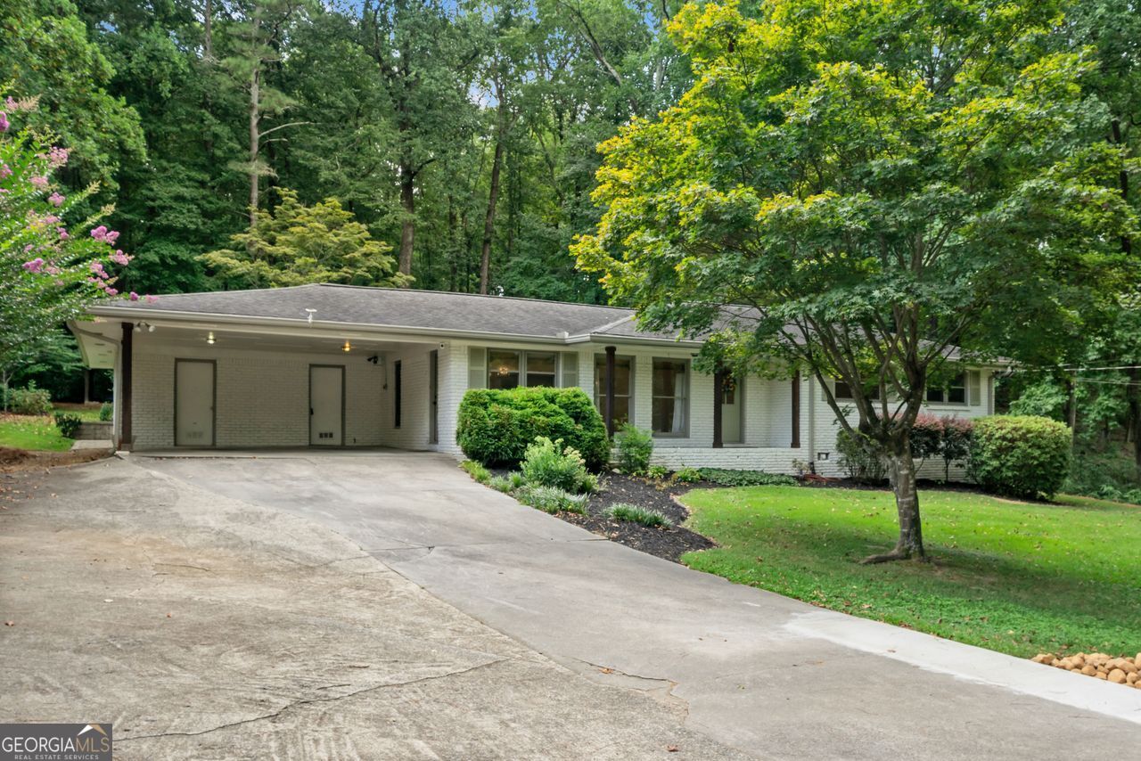 A RARE INCREDIBLE FIND in Smyrna convenient to everything. Open and spacious custom renovated brick ranch. 4 beds, 3 baths. A private oasis. Entrance foyer, lounging area in the kitchen, new kitchen with quartz countertops, huge island, 36-inch electric oven and gas cooktop, custom cabinets, top of the line ss appliances, new plank floor throughout living areas, master bedroom and bath. Split bedroom design with 3 additional carpeted bedrooms. A private paradise professionally designed backyard including an outbuilding and large family/party paver patio with pergola. A large family room with a fireplace that opens into a large, windowed sunroom. Double carport with a one-step entry to the kitchen. Not just a nice home, a uniquely wonderful one-of-a-kind home!