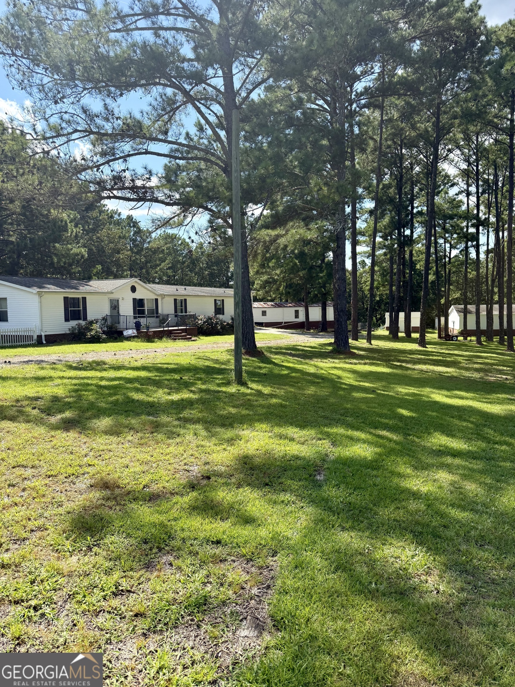 40.5+/- acres with a home and guest house in Houston County, GA. Located on a quiet road in north Warner Robins, this property offers privacy, space, and multiple possibilities. The 4-bedroom, 3-bath home is in the process of being renovated, and most of the building materials on site will remain. A fully finished guest retreat provides additional living space with a full bathroom, bar, and hot tub. The land is two parcels combined (25.5 acres and 15 acres) for a total of 40.5 continuous acres that features both open ground and wooded acreage full of wildlife. Multiple storage buildings, a large open lot, and plenty of parking for boats, RVs, or equipment. With two septic systems already in place, the property only needs a well to complete the setup. Key Features: +/-40.5 acres, two parcels combined (approximately 25.5 acres & 15 acres) 4 bed, 3 bath home currently under renovation Finished guest retreat with full bath, bar, and hot tub Wooded acreage with abundant wildlife Large open lot for equipment, parking, or multiple uses Multiple storage buildings and workshop. Two septic systems (well needed) Ample parking for RVs, boats, and more Building materials on site convey with property Close to Robins AFB and Macon To schedule a showing, please contact Chris Ryan-listing agent at 843-441-7636 .