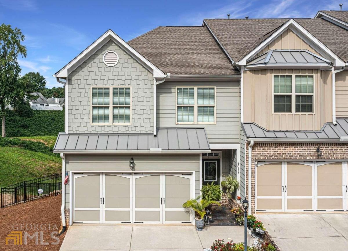 An immaculate townhome located at the end of the cul de sac with private views of the neighborhood greenspace! Beautiful & move-in ready - built in 2015. Gorgeous hardwood floors throughout the main level, the master bedroom, the stairs and the upstairs hallway. Upstairs boasts a laundry room, 3 bedrooms which includes a spacious master bedroom along with a large master bath that features granite counters, a double vanity, walk-in closet and separate tub/shower. Open concept on the main level with great room, dining area and kitchen. The kitchen has black cabinets, granite countertops and Stainless Steel appliances. The finished basement has a large, tiled room that can be used for an entertainment area or a 4th bedroom and a full bath. The basement has an exterior door that leads to the back patio & fenced side yard. The back deck off of the great room is truly one of the most private in the subdivision. One of Duluth's finest townhomes: close to Johns Creek & easy access to Peachtree Industrial Blvd.