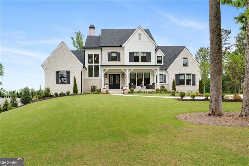 Beautifully appointed, OBIE Award Winning Home. Gated Community of Mayfair Estates. This spectacular Front Porch home is move-in ready and has everything! Main level Owners Suite has a private porch off the back and overlooks pool and private backyard. Owners Suite also includes luxurious bathroom with soaking tub, spa shower, and double vanities, huge walk-in closet with packing table & built-ins also has access to the main level Laundry Room. Very open plan features spacious Great Room with beamed ceiling, fireplace, doors out to covered back veranda and backyard, large open dining area, immaculate kitchen with top-of-the-line appliances, lots of cabinet space, walk-in 'Pinterest' pantry, and pass through window to outdoor Kitchen area. Separate large Dining Room is located off Foyer. Large Guest Bedroom with walk-in closet and private bathroom is also located on the main level. Side entrance leads to mudroom with built-ins. Staircase has amazing brick wall feature and leads to upper level featuring reading nook, upstairs Laundry Room, three sizable bedroom suites - each with walk-in closet and private bathroom, and enormous bonus space over the four car garage that includes private storage or exercise space, spacious sitting/gaming room, large game room, and four-bed Bunk Room. Finished terrace level is wonderful for entertaining and includes a wine cellar, two-tier Theater Room, Family Room, Bar Area, large Billiard/Game Room, Pool Bathroom, and large Guest Suite/Office with walk-in closet and private bathroom. Home is situated on a private, level lot. The backyard is fenced and includes a salt-water pool, relaxing hot tub, large covered back veranda with fireplace, dining space, and outdoor kitchen, and lots of running around space. Level driveway has two separate parking places and leads back to four car garage. Home is immaculately maintained and is barely lived in.