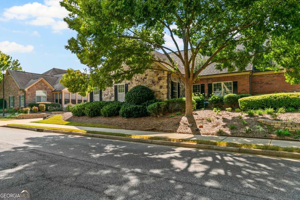 Welcome Home to Brookhaven of East Cobb! Tucked away on a peaceful, tree-lined street yet only moments from shopping, dining, and easy access to I-575 and I-75, this beautifully designed Jim Chapman neighborhood offers the perfect blend of comfort, convenience, and style. Step inside to a bright, open-concept kitchen and family room filled with natural light-ideal for entertaining or relaxing with the family. The spacious main-level primary suite features an en suite bath and generous walk-in closet. Two additional bedrooms and full bath provide plenty of space for guests, a home office, or hobbies. Enjoy your morning coffee or a relaxing evening in the charming sunroom or enclosed porch. The conveniently located laundry room off the kitchen is plumbed for a sink, adding even more functionality. Upstairs, discover a versatile bonus space complete with an additional bedroom and bath-perfect for overnight visitors or a private retreat. Special touches throughout the home include two light tubes bringing in extra sunshine, under-cabinet lighting in the kitchen, and a recirculating hot water system for comfort and efficiency. Don't miss your chance to call this sought-after community home!