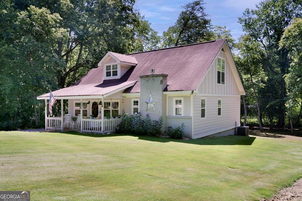COME RELAX IN THE NORTH GEORGIA MOUNTAINS WHILE LISTING TO THE SOOTHING SOUNDS OF THE CREEK! Enchanting Furnished Cottage, fully renovated in 2018 with modern farmhouse flair with mountain views. Nestled on a private, partially wooded lot with a flat backyard and gentle front yard, featuring serene creek frontage and a cozy fire pit. Offers 2 bedrooms (1 on main, 1 upstairs) and 2 full baths. Highlights include a striking stacked stone gas log fireplace, kitchen with granite counters & stainless appliances and a comfortable front porch to relax on and enjoy the surrounding views.