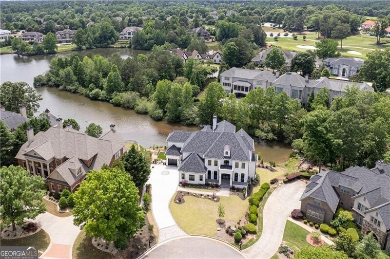 Timeless luxury. Uncompromised craftsmanship. Stunning lake views. Experience the pinnacle of country club living in this NEW CONSTRUCTION home from Hyde Park Homes, Inc in prestigious, gated Sugarloaf Country Club. Meticulous pursuit of perfection is evident in every detail of this home, and the home has some wonderful attributes such as TWO FULL MASTER SUITES PLUS ELEVATOR to all three levels. The stage is set as you enter the front iron doors into the luxurious and bright foyer with impressive and unique circular staircase surrounded by windows and handsome marble floors. The main floor is a showcase of elegance and perfect for entertaining with the living room and stylish bar open to the dining room with lake views. Adjoining the formal areas is the Chef's Kitchen with its white oak cabinets, high end stainless appliances, gorgeous Calacatta Marrochino quartz counters and backsplash. Adjoining the kitchen are the breakfast room and spacious keeping room with modern fireplace, and just around the corner is a scullery (or spice kitchen) which provides a second kitchen area for entertaining both indoors as well as outdoors on the porch with lake views. The luxurious main master suite is also on the first floor with continuing lake views, a spa-like bathroom and sumptuous closet. Completing the first floor are the stately study, extra-large laundry room, mud room, and ELEVATOR to all levels. A second full master suite can be found on the second floor with great lake views, two closets, and opulent bathroom suite. There are an additional three bedroom suites and a second full laundry on the second level. The finished terrace is definitely one-of-a -kind with its 12' ceilings, second full kitchen/entertaining bar, wine room, huge theatre room, fireplace, game room PLUS billiards room, exercise room, gorgeous guest bedroom suite and so much more! A few more exquisite details include Pella exterior windows and doors, 5" White Oak Hardwoods, 8" solid masonite interior doors on all levels and stunning landscaping package. Your new home is ready for move-in!