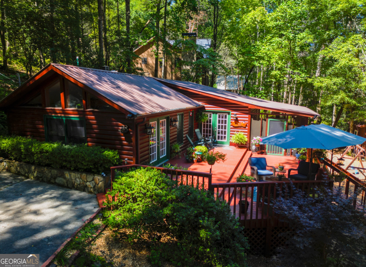 Creekfront Cabin Retreat on Fighting Town Creek 308 Hemlock Trail Blue Ridge, GA Welcome to your mountain getaway on the rolling waters of Fighting Town Creek! This charming 2-bedroom, 2-bath cabin is the perfect blend of comfort and adventure. Step inside and you'll find a warm wood interior with a vaulted great room, cozy stone fireplace, and plenty of natural light pouring in through the windows. The outdoors is where this cabin truly shines relax on the expansive decks, enjoy morning coffee in the screened porch, or gather around the fire pit right beside the creek for evenings filled with roasted marshmallows and laughter. The sound of the rushing water sets the perfect backdrop for relaxation. For those who love a little adventure, put in a tube at the Power Dam Bridge and float for about 1.5 hours right back to your own backyard. On warm days, you can swim in the creek, cast a line, or simply unwind with the soothing sounds of nature all around you. Whether you're looking for a full-time home, a weekend escape, or a short-term rental investment, this cabin delivers it all -privacy, water frontage, and that quintessential Blue Ridge charm. Come experience the magic of Fighting Town Creek where relaxation meets adventure.