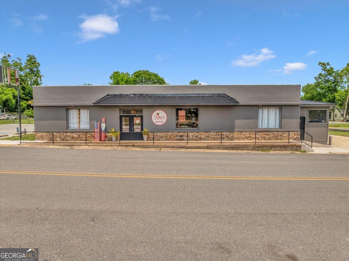 Looking for a fresh start in the restaurant business? This newly updated commercial property offers everything you need to launch your culinary venture right away. Situated on a prime corner lot just one block from Main Street, this charming establishment puts you in the center of Eastman's vibrant community. The completely renovated 2,800 square foot restaurant space can accommodate 80-100 diners, making it perfect for everything from casual dining to special events. Your customers will appreciate the flexible dining options, with both indoor seating and outdoor areas to enjoy Georgia's beautiful weather. For those on the go, the convenient drive-through window provides additional revenue potential. Parking worries? Not here! The property features two dedicated lots - a paved, handicapped accessible area with designated spaces, plus an additional gravel lot that can accommodate up to 20 vehicles. Paved walkways lead to both front and back entrances, ensuring accessibility for all your patrons. The interior has been thoughtfully updated with new flooring throughout and the entire structure is protected by a new metal roof. Behind the scenes, the building has been completely replumbed and rewired with updated infrastructure and natural gas hookup. The professionally designed kitchen features an efficient zone layout with 7-8 distinct areas, plus there's a dedicated office and employee restroom. Location is everything in the restaurant business, and this property delivers! Situated directly across from Eastman's charming pocket park, your diners can enjoy the colorful mural and watch locals engage in games like cornhole and shuffleboard. The park's water fountain and benches create a pleasant atmosphere that complements your dining experience. The property also includes a distinctive red barn structure that evokes the charm of a bygone era - perfect for expanding your business or creating a unique event venue. Restaurant equipment and furnishings are available for separate purchase, allowing you to hit the ground running. With its turn-key readiness, prime location, and thoughtful renovations, this commercial property represents an exceptional opportunity to establish your culinary presence in Eastman's thriving community. Contact Stephanie or Becky today for your showing appointment.