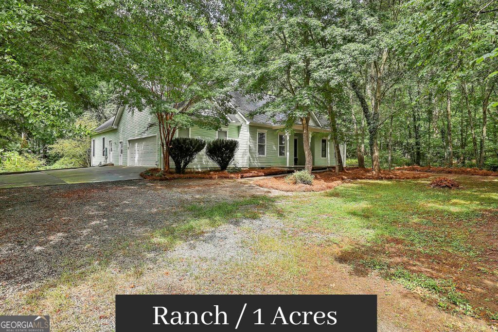 Custom ranch home featuring 4 bedrooms and 3.5 bathrooms, along with a sunroom and a large screened-in porch. The 1 acre lot is not in a subdivision so no HOA. The oversized kitchen boasts three pantries-wow! The primary suite includes his and her closets, a renovated master bath, and opens up to the sunroom, which is currently being used as a gym. The split bedroom plan is laid out on the main level, where the spacious living room opens to the screened porch. The kitchen is a chef's delight, equipped with extensive countertops, a walk-in pantry, a breakfast bar, and ample storage space. There's also a large laundry room with plenty of storage options throughout the home. The sun porch offers beautiful views of the wooded yard, making it a great spot for enjoying nature. Additionally, there are two more bedrooms and a bathroom on the main level. Upstairs, you'll find the 4th bedroom or bonus room, complete with the 3rd full bathroom. Conveniently located just minutes from Trilith Movie Studios and only 13 miles from Hartsfield-Jackson Atlanta International Airport, this home is perfectly situated for both relaxation and accessibility.