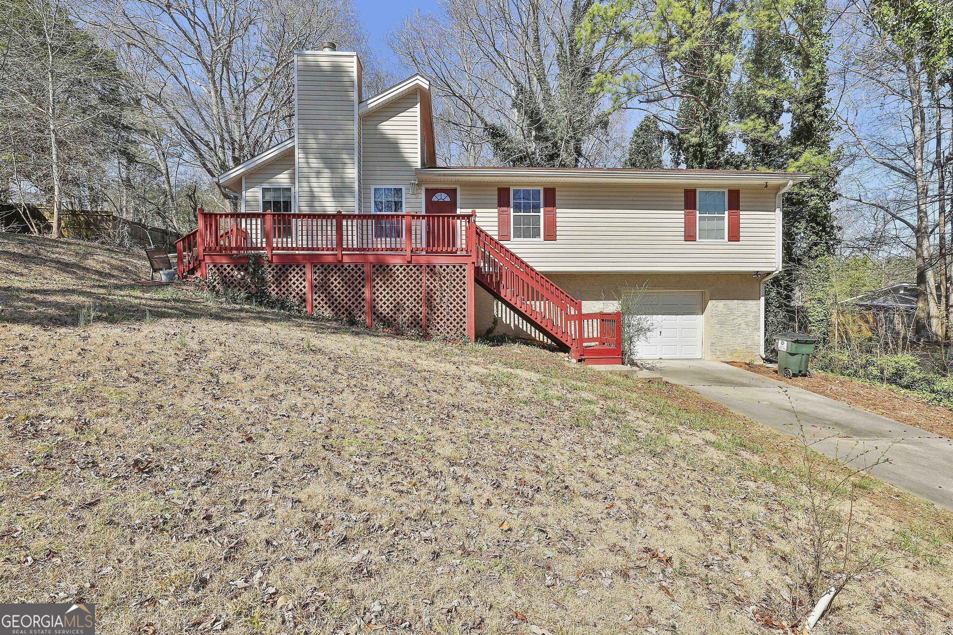 Welcome to your new home in Newnan, GA! This charming three-bedroom, two-bathroom house offers a cozy fireplace, vaulted ceilings, and beautiful wood floors. The spacious eat-in kitchen has a dishwasher, microwave, and refrigerator, perfect for preparing meals and entertaining guests. Enjoy the serene wooded lot from your private deck, or relax in the living room with exposed beams adding character to the space. With a separate dining area and laundry room, this house has everything you need for comfortable living. Don't miss out on this excellent opportunity to call this 3 Bedroom 2, Bath, Garage house your new home!