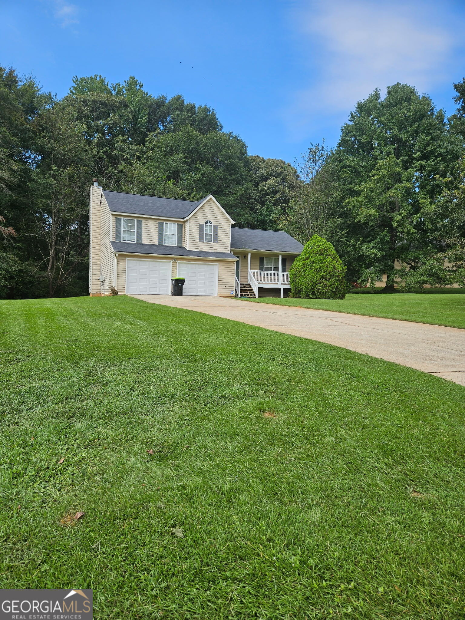 Welcome home - a delightful 3-bedroom, 2.5-bathroom home offering comfort, convenience, and Southern charm. Separate formal living and dining room. Enjoy relaxing evenings on the inviting rocking chair front porch, perfect for morning coffee or winding down after a long day. Inside, you'll find a spacious layout with natural light throughout. The home features a 2-car attached garage, providing plenty of storage and parking. Sitting on a large yard, there's room for entertaining, play, or relaxing in your outdoor space on the patio. New appliances - gas stove and dishwasher, roof replaced within last 5 years and new paint throughout interior, new garage doors and porch railing. HVAC installed within last 3 years. Conveniently located near shopping, dining, and major highways, this home combines peaceful living with everyday accessibility. This gem is priced to sell - don't miss your opportunity to make it yours!