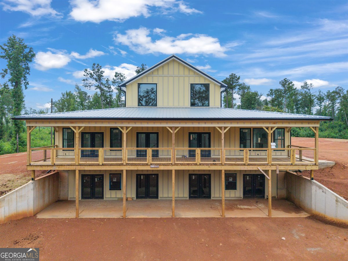 Did someone say Barndominium?! This once-in-a-lifetime opportunity is calling your name! Sitting on 31.43 acres of beautiful Monroe County land, this custom-built barndominium is offered at an unfinished stage-giving you the chance to add your personal touches! The seller/builder will complete the main level at list price, featuring 1 bedroom, 1.5 baths, a stunning open-concept design, butcher block countertops, wood ceilings, LVP flooring and jaw-dropping views from the front porch that always seems to catch a peaceful breeze. Want more space? You've got it! The upstairs (720 sq ft) offers room for 2 more bedrooms and a bathroom, and the 1,800 sq ft walk-out basement is stubbed for 3 additional bedrooms, another full bath, and a spacious living area. The builder is open to working with the buyer on separate contracts to complete these areas. Garage placement? Still flexible! Choose a side or rear-entry garage based on your needs. Horses are welcome, and the space offers both privacy and potential. Plat available in documents. Square footage is builder-provided and estimated-buyer to verify if important. The road getting back to this property is private and shared. Don't miss your chance to make this unique barndominium your own private retreat!