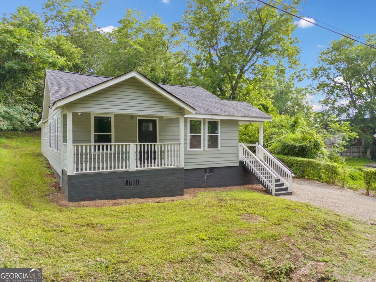 A stunningly remodeled 3 bedroom, 2 bath one level home in the heart of Rome, beautifully transformed inside and out, and ready for its new owner. Upgrades include, but are not limited to: a new roof, HVAC system, water heater, stainless steel kitchen appliances, luxury vinyl flooring, new cabinetry and vanities, Hardie Plank siding, upgraded insulation, Energy Star-rated windows, and a moisture barrier in the crawl space. This home features two charming porches-one private porch exclusively for the front bedroom, and another side porch that leads directly into the living room. A spacious deck extends into the private backyard, offering the perfect setting for entertaining, relaxing, or simply enjoying the outdoors. With so many inviting outdoor spaces, the potential for open-air living is endless. Opportunities like this don't come often-book your showing today. Interior photos will be uploaded on 6/21. No showings until Sunday 6/22