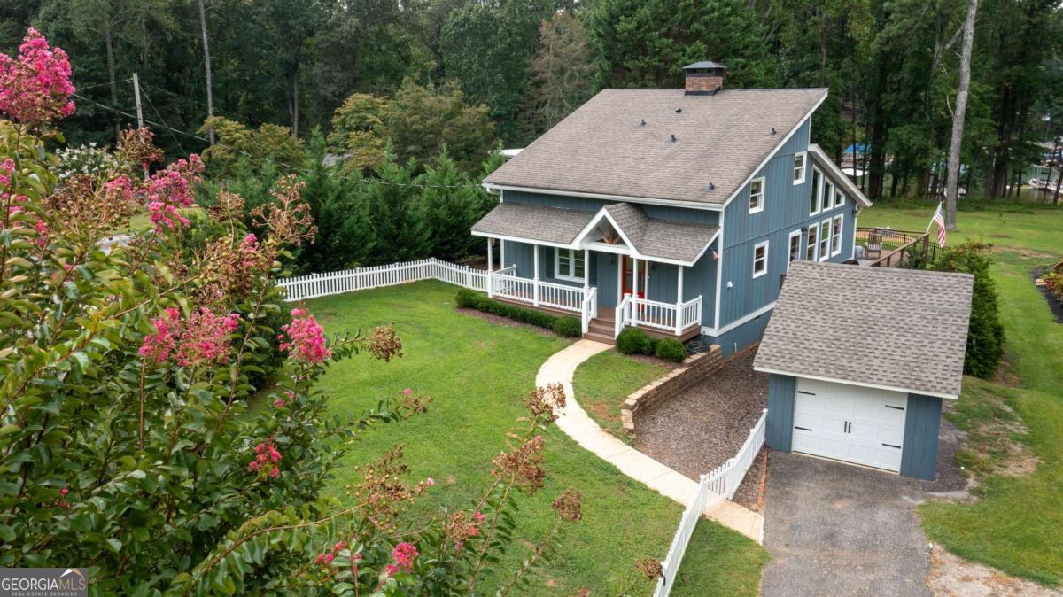 Need to get away to escape the congestion and traffic? This IMMACULATE and completely updated lakeside home with YEAR AROUND LAKE VIEWS is perfectly located on South Lake Lanier with a BRAND-NEW Wahoo private dock! LOCATION PLUS!! Baldridge and Habersham Marinas are only minutes away by water, and GA 400, Cumming's City Center abundant restaurants, groceries, retail, and medical facilities, to include Northside's Forsyth Hospital campus, are at your fingertips over the road! This ADORABLE residence is remodeled to include the Kitchen, Master Bath, Laundry, all flooring, paint, and appliances! All NEW or newer windows in Kitchen, Master Bedroom, and Great Room. A half Bath was recently added by the previous owners and the interior staircase completely rebuilt. The crawl space has been treated, renovated, and inspected by NuTech. The MAIN LEVEL boasts a wide open layout with the Master Bedroom, Laundry, Kitchen, Dining, half Bath, vaulted Great Room w/soaring brick fireplace, and TONS of natural lighting! The Owner's Bedroom is on MAIN and two additional Bedrooms are upstairs for visiting guests or family. Savor the lake views and breezes from the Screened Porch, wrap-around deck, and firepit! The Corp line is well away from the foundation, and the home has a coveted mowing permit. Easy walk from the grassy yard to the path leading to the NEW DOCK with 12 foot wide boat slip! Available for a quick closing so you can enjoy the remaining Summer months and wonderful Fall weather on the lake! This is a RARE South lake property under $1 Million!
