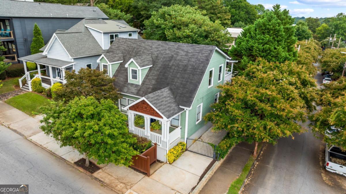 Spacious, turn-key home in Old Fourth Ward! Featuring historic details, modern updates, and an unbeatable location, this turnkey gem combines classic Atlanta charm with thoughtful modern updates, in one of the best locations in town. Beautifully fenced front yard and rocking chair front porch enhance the privacy and curb appeal of this well-maintained 1930s home. Enter the front door to find a flowing floorplan with original heart of pine and oak hardwood flooring, 2 original fireplaces, and elegant arched doorways. Enjoy comfortable everyday living with visibility from kitchen to living room, while enjoying some separation of spaces. The main level also holds two bedrooms that share an updated bathroom, plus a spacious laundry room for added convenience. Upstairs, escape to your private retreat in the oversized primary suite. This luxurious space includes a spa-like bathroom with jetted tub, separate stand-up shower, water closet, and double vanity. Extra closet space ensures you'll never run out of room for your wardrobe. Step out onto your private deck overlooking the peaceful, private fenced backyard below. Speaking of the backyard - it's an entertainer's paradise. The large grilling deck and covered patio create multiple outdoor living spaces, while the metal gate provides secure parking for two vehicles. The fully fenced yard offers complete privacy and security. The location is incredible - you're perfectly positioned near the eastside Beltline trail with easy access to Atlanta's best shopping, dining, and top-rated schools. This is Atlanta living at its finest.