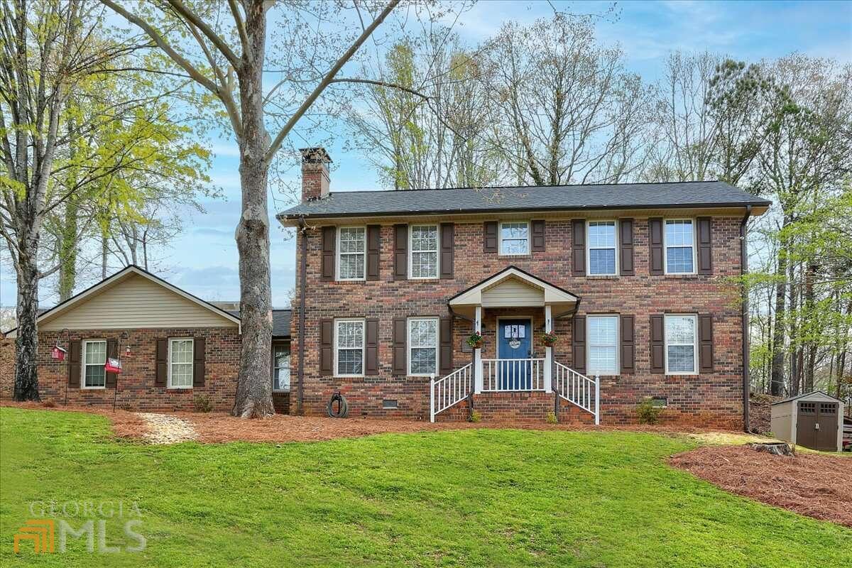 RENOVATED home near Lake Lanier! New carpet! Custom kitchen cabinets, granite counters, marble backsplash, under counter lights, SS appliances, soft close drawers. Roof replaced 2017. HVAC and water heater replaced 6 yrs ago. Premium laminate flooring, new lighting, door knobs, faucets, PVC insulated windows, new blinds, WIFI programmable thermostat. 2 car side entry garage with extra large driveway-perfect for work vehicle or trailer, boat, etc. Extended back patio, updated bathrooms, new sheet rock, 3 sides brick. Producing apple and pear trees on property. Seasonal views of Lake Lanier!