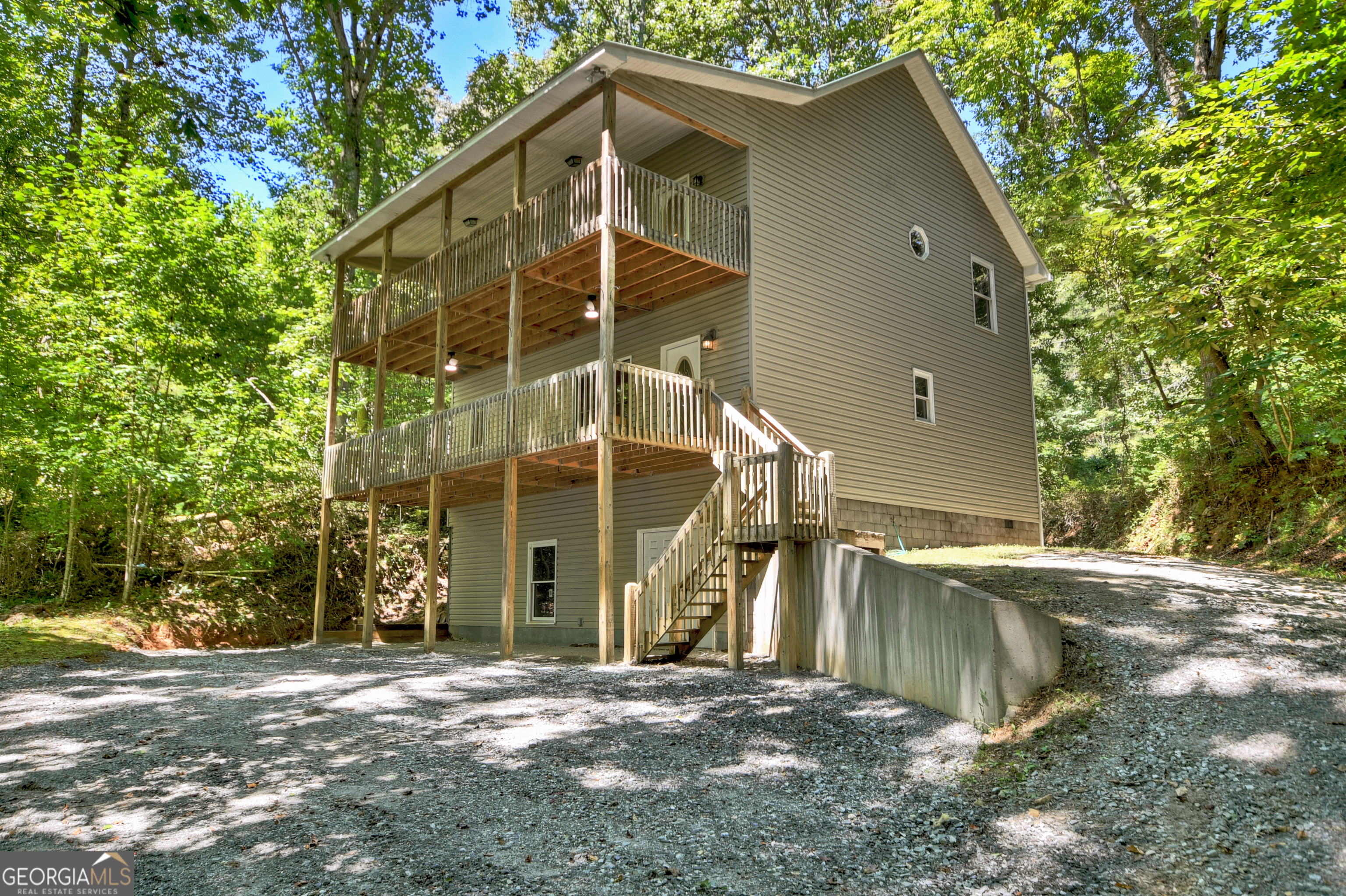 Affordable, spacious, and move-in ready! This charming 3-bedroom, 2-bath home is everything you've been searching for. Designed with easy living in mind, it features low-maintenance vinyl siding, a generous parking area, and an expansive deck on the main level-perfect for outdoor entertaining, family gatherings, or simply soaking up the mountain air. Inside, you'll be impressed by the bright and airy feel created by hardwood floors, large rooms, and neutral paint tones that complement any style. The main level offers a welcoming living room, a full bath, a dedicated food pantry, a spacious laundry room, and a large kitchen that's ready to bring everyone together. Upstairs, you'll find two roomy secondary bedrooms along with a private primary suite that boasts its own balcony retreat-the perfect spot for a morning coffee or a quiet evening unwind. This home also includes a partial crawl space, ideal for storage, giving you the extra room you need to keep things organized and out of sight. Conveniently located between Blue Ridge and McCaysville, you'll enjoy quick access to shopping, dining, outdoor recreation, and all the charm of North Georgia living.