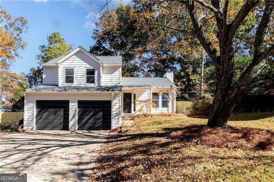 Welcome home to this beautifully updated 3-bedroom 2.5-bath property in the heart of Acworth. Freshly painted inside and out, this home offers a clean, modern look with thoughtful updates throughout. The inviting living room features a vaulted ceiling, large windows that fill the space with natural light, and a cozy fireplace that anchors the open layout. The kitchen has been completely refreshed with brand new shaker cabinets, elegant quartz countertops, and stylish black hardware, creating a space that is both functional and sophisticated. All bathrooms have been updated with new vanities, quartz surfaces, and modern fixtures, giving each space a fresh and contemporary feel. The primary suite offers a generous layout with a spacious walk-in closet and a beautifully updated bathroom featuring a new double vanity, designer quartz countertops, and updated plumbing fixtures that create a spa-like retreat. Additional highlights include new flooring throughout, updated lighting, and all-new plumbing fixtures, switches, and outlets, making the home truly move-in ready. Step outside to a large screened-in porch overlooking the newly fenced backyard, perfect for relaxing or entertaining. A newer six-year-old roof and a brand-new fence provide peace of mind. With a two-car garage and convenient access to downtown Acworth, Lake Allatoona, shopping, and restaurants, this home blends comfort, style, and location beautifully.