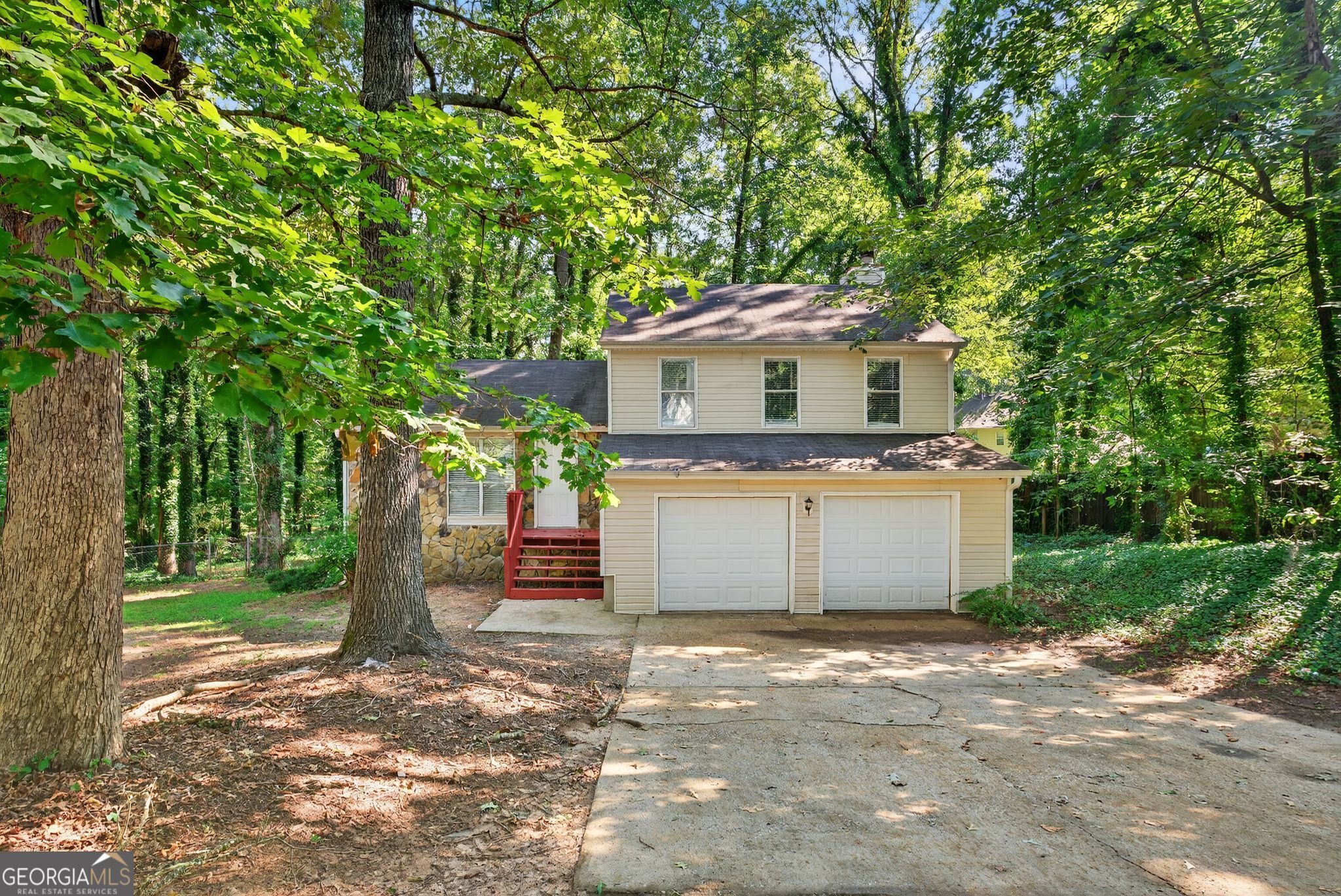 Welcome to this beautifully maintained 3-bedroom, 2-bath split-level home in Stone Mountain's sought-after Fox Valley subdivision. The spacious living room features a cozy fireplace, while a separate dining area offers the perfect setting for meals or entertaining. Step out onto the back deck to enjoy outdoor relaxation or gatherings. A generous two-car garage provides plenty of space for parking and storage, and the classic stone exterior gives this home timeless curb appeal. Nestled on a large lot near amenities, this home combines comfort, convenience, and style in an ideal location.
